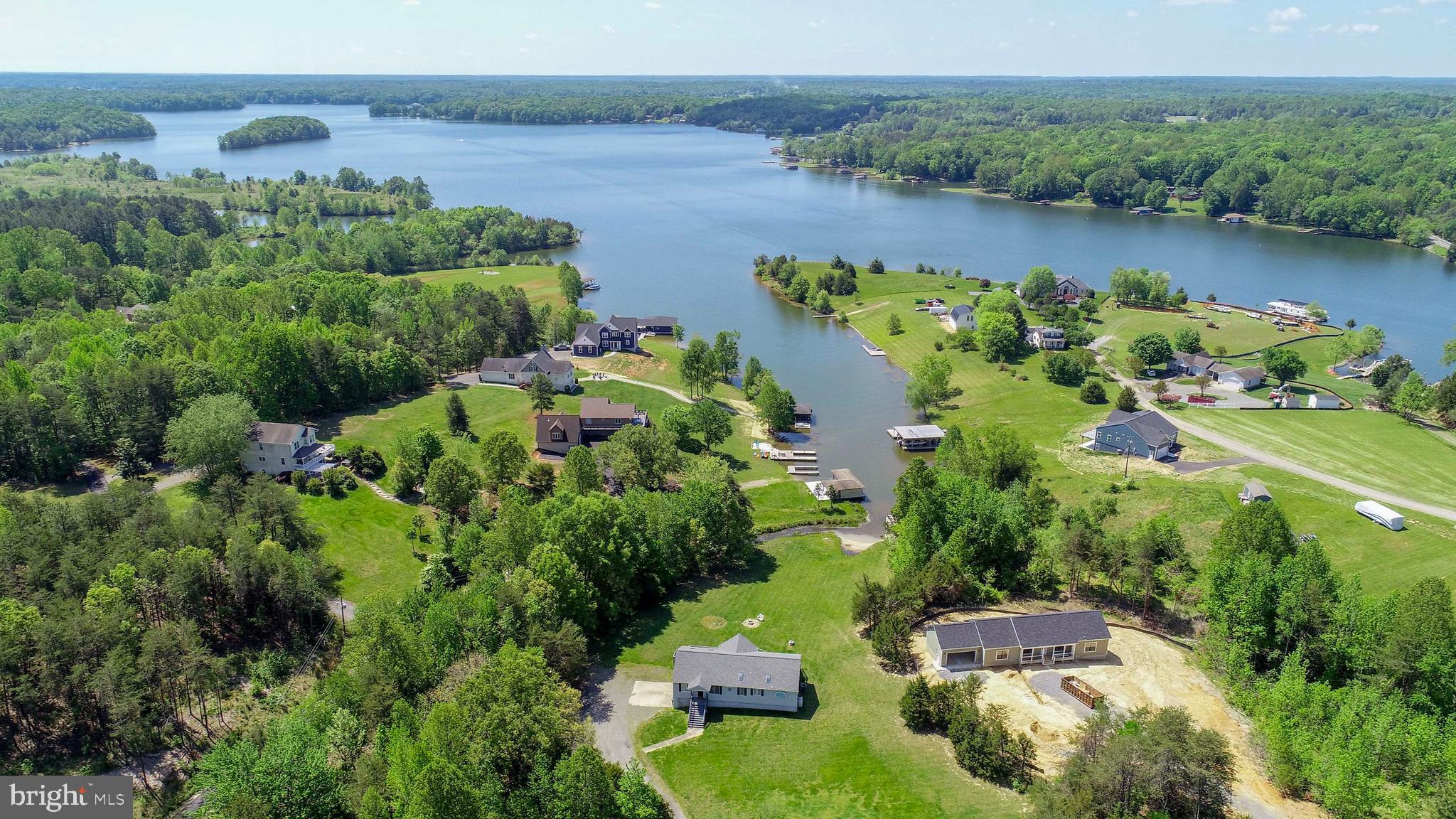 HUGE PRICE REDUCTION ON THIS LAKE ANNA WATERFRONT HOME--Discover the perfect blend of luxury and tranquility with this stunning waterfront home, offering great lake views and modern amenities. Spanning 3,330 finished sq ft, this property features 4 spacious bedrooms and 3 full baths, nestled on a generous 3.29-acre lot with approximately 75 feet of pristine waterfront. Enjoy the freedom of no subdivision restrictions or covenants, allowing you to truly make this home your own. The open floor plan is designed to maximize natural light, with expansive windows framing picturesque lake views. The kitchen is a chef's dream, boasting granite countertops, stainless steel appliances, and a seamless flow into the dining area and Great Room. The Great Room itself is a cozy haven with a gas fireplace and panoramic views of the water. The primary suite is a private retreat, featuring sliding glass doors to the deck, a luxurious bath with a large tiled shower, soaking tub, double vanities, and a spacious walk-in closet. An additional bedroom and full bath complete the main level. The finished walkout basement offers even more living space, with two bedrooms, a full bath with a tiled shower, and a versatile living area with built-in cabinets and stunning lake views. The utility room is well-appointed with cabinets, counter space, a utility sink, and a washer and dryer. Outdoor living is equally impressive, with a level lot, a recently redone dock with durable Trex decking, and a retractable awning for shaded relaxation. The oversized two-car garage provides ample storage, complemented by an additional storage shed. This home is equipped with modern updates, including a new roof, new skylights, recent HVAC (2023), and a new furnace (2024). High-speed internet ensures you stay connected, while the private, paved road offers peace and seclusion. Furniture can convey, making this home move-in ready. Don’t miss the opportunity to own a slice of paradise in this private lakeside cove with unparalleled views and top-tier amenities. Schedule your showing today and experience waterfront living at its finest!