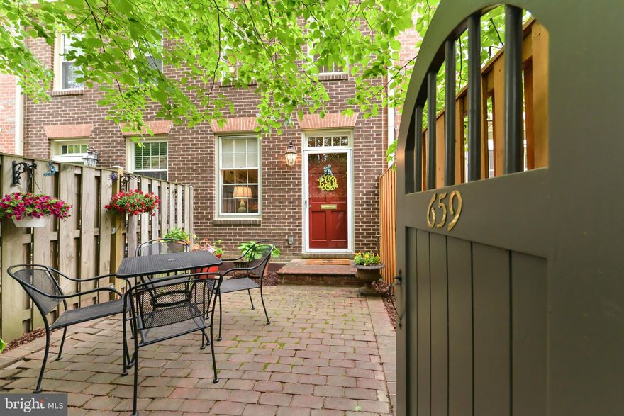 Slip thru the garden gate to a private bricked patio. Gleaming floors, elegant moldings, custom blinds/shutters plus fireplace offer a serene backdrop. Quartz counter tops, stainless appliances and beamed ceiling in kitchen add panache. Bosch stack W/D. Unfinished 3rd floor w/ window, crawl space, plus separate bike storage. Parking (2) at your back door. If you can bear to leave, Old Town awaits!