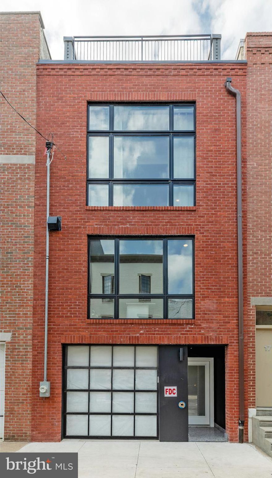 Style. Space. Light. Functionality. Location. Parking. 10-Year Tax Abatement. 1714 Montrose has it all. Come tour this beautiful, light-filled, 4-story new construction home with a fabulous floor plan, three outdoor spaces, and located just a few doors down from Carpenter Green Park in the Stanton Elementary catchment area. You will enter the property into a lovely foyer, sunlit through the frosted glass entrance door and the perforated block separating you from the sunlit garage. You will notice that the floors throughout the first floor and the stairs ascending to the living level are laid with beautiful terrazzo tile. The first floor can function as a private oasis from the remainder of the house. There is a lovely tiled full bath adjacent to a spacious 4th bedroom (or office or family room). This space opens to a private patio, creating an indoor/outdoor experience. The living level is the heart of this home. A spacious living room with high ceilings showcases a beautiful media wall featuring recessed shelf-lined arches and a recess for artwork or a monitor. A wall of glass opens to a fabulous terrace with a Mediterranean feel that has some truly beautiful sight lines while remaining relatively private in the Urban surrounds. A few steps up from the living area is an open kitchen-dining area. There is room for a large table for gatherings of family and friends. The kitchen is stunning and brilliantly designed for functionality as well. A long central island anchors the space and is flanked on one side by a long row of cabinets centered around a six-burner range. Above the range is a beautifully sculpted hood, flanked by open shelving supported by a gorgeous tiled backsplash. On the opposite wall is extensive cabinetry highlighted by a tiled arch with open shelving and a Sub-Zero refrigerator and wine cooler. One flight up is the primary suite that could have been extracted from a luxury spa. This very spacious, naturally lit bedroom has an adjacent pass-through closet that opens to a finely appointed bathroom. The bathroom features a long double vanity, private water closet with bidet toilet, and a wet room featuring a beautifully tiled shower area, including a built-in shower bench and a freestanding tub. Also on this floor is a second room that would make a great home office or nursery. The fourth floor offers two more well-proportioned bedrooms, another brilliantly designed bathroom, and a laundry station. A few more steps up takes you to an expansive wet bar in the pilot house, which opens to a large roof deck with an expansive view, and yes, a hot tub to further your spa at home experience. Truly, one of the most extraordinary properties to be offered in Graduate Hospital in memory, this is an opportunity that you should not miss out on.