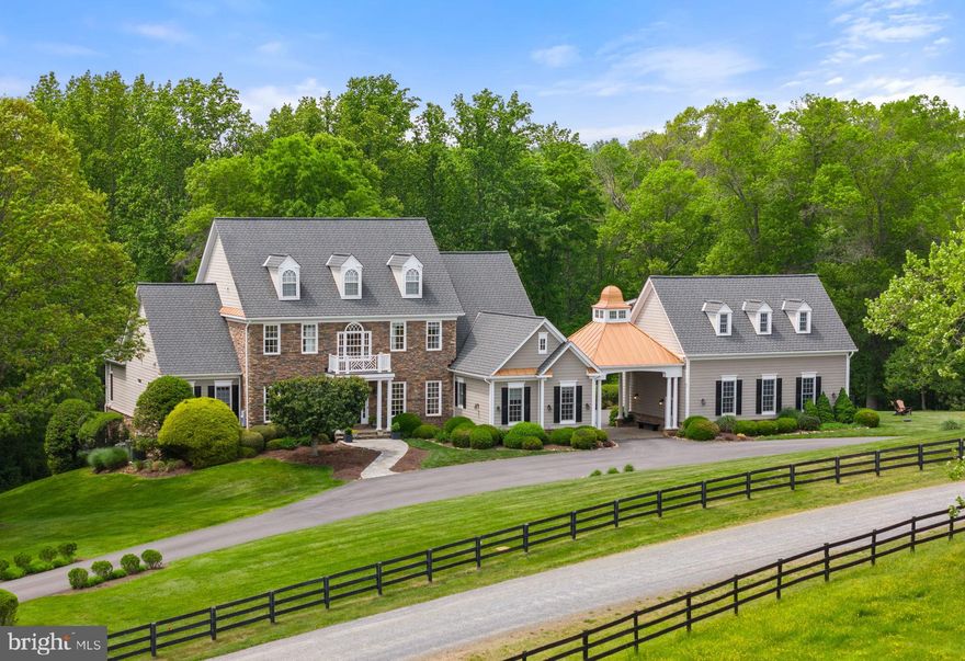 Nestled on over 7 acres overlooking the Little River, "Eden Glen" stands as a testament to meticulous craftsmanship and timeless elegance. Situated within a secluded enclave of five custom-built residences along Light Horse Court and just east of the town of Middleburg, this extraordinary property offers a sanctuary of natural beauty and refined living. The setting is serene, offering a private retreat from the bustle of everyday life while still providing easy access to Dulles International Airport and downtown Washington. "Eden Glen" has been lovingly maintained and thoughtfully updated by its current owners, who have preserved its essence while enhancing its allure. Gleaming Brazilian cherry floors, high-end granite countertops, and commercial-grade appliances are just a few of the luxurious upgrades that adorn this exceptional residence. Step inside to discover traditional yet comfortable living spaces designed for both relaxation and entertainment. The main level features a gracious living room, formal dining room, and a gourmet kitchen that seamlessly flows into the inviting family room. A wood-paneled library provides a quiet retreat for work or study. The primary bedroom suite, located on the main level, is a haven of tranquility with its additional sitting room and lavish ensuite bath, complete with a steam shower, soaking tub, and spacious walk-in closets. Upstairs, three guest bedroom suites offer comfort and privacy, one boasting its own ensuite full bath. The fully finished walk-out lower level is where a world of entertainment awaits. A recreation room with a bar, glass wine cellar, a dedicated movie room, an exercise room, and ample storage space provide endless possibilities for leisure and relaxation. Outdoor living takes center stage at "Eden Glen," with a multitude of spaces designed for enjoyment and relaxation. A walk-out deck on the main level offers an open seating area, while the lower-level terrace features an outdoor kitchen, seating area around a unique stone chimney, and a hot tub, perfect for gathering with loved ones. A meandering stone walkway leads to a one-of-a-kind pool complex, nestled just below the house. The heated pool features five built-in sitting benches and a tanning ledge, surrounded by extensive stone decking and lush landscaping illuminated by specially designed lights. Connected to the main residence via a porte cochere is the Carriage House, boasting a three-car garage and flexible space above, ideal for a studio, home office or guest quarters. If you're seeking a retreat in the heart of hunt country with access to miles of walking trails, "Eden Glen" offers unparalleled luxury and serenity. Don't miss the opportunity to make this extraordinary estate your own. Starlink internet conveys. Schedule your private tour today and experience the epitome of country living. Be sure to watch the video!