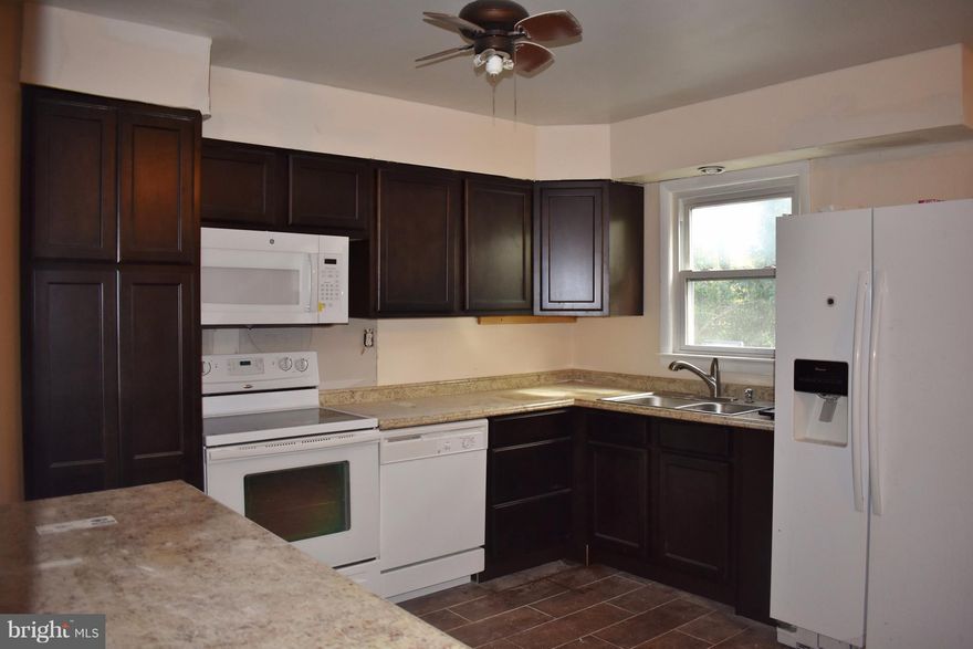 This lovely home has been totally updated with new carpet, fresh paint throughout, remodeled bathrooms, lighting and brand new kitchen. Finished basement with walk out to the patio. Additional bonus Room and kitchenette located in the basement. Fenced backyard with a shed and private driveway for parking. Close to NASA, UMD, and I-495