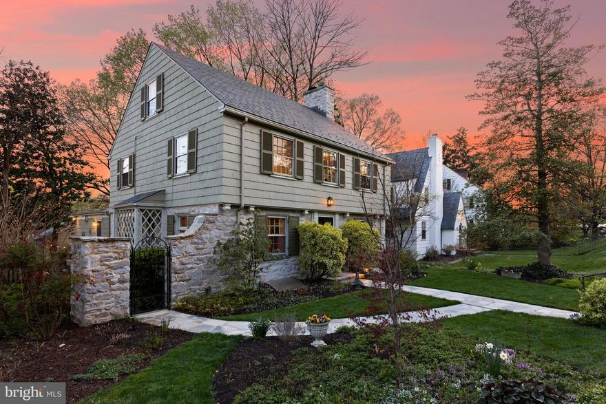 Trust your instincts. This handsome stone and soft spring-green cedar shake colonial is bordered by remarkable gardens and has been meticulously maintained, updated, and seamlessly expanded to offer four levels of finished and versatile living space. Timeless interior details include oak hardwood floors, deep reveal windowsills, and exquisitely crafted millwork. A charming foyer with half-bath adjacent to a cozy study - once the original kitchen opens to a spacious formal dining room. The formal living room with wood burning fireplace features display cabinets flanking French doors leading to an extraordinary bluestone covered veranda with vaulted tongue-and-groove ceiling, ambient lighting, and cascading water feature - perfect for quiet retreat, alfresco dining, and festive Maryland crab feasts. Below, the fenced rear level lawn, gardens with fieldstone sitting walls, and bluestone patio with firepit beckon friends to enjoy. The open-air porch conveniently connects to a remarkable light-filled cook's kitchen equipped with custom cherry cabinetry, a center island with breakfast seating, stainless appliances including a new ZLINE dual fuel 9-burner 60" gas range with double ovens, Travertine tile flooring, and an expansive wall with display shelves and cabinetry. This large area of the kitchen with window seating offers flexible space for casual dining and a homework station. The second level offers a spacious primary suite with a dressing room, two double closets, and an ensuite bath. Bedrooms two and three are generous with spacious closets, window seats, and walls of bookshelves and share a full bath. The third level offers a large storage room and two additional bedrooms currently serving as home offices. The exceptional walk-out finished basement features a temperature-controlled wine room, convenient laundry, second half-bath, and a family recreation room with a party bar and new gas fireplace. A second walk-out basement constructed below the kitchen addition provides room for workshop or abundant storage for bikes, kayaks, lawn furniture, and gardening equipment, just steps from the true 2-car garage. The slate roof on the main residence was replaced in 2010. The property has a new gas water heater, HVAC upgrades, many new appliances, basement waterproofing, audio, and garden irrigation systems. Embrace a fine home in a neighborhood that celebrates its history, surrounding natural beauty, and the winding sidewalks leading to the scenic Lakes of Homeland.