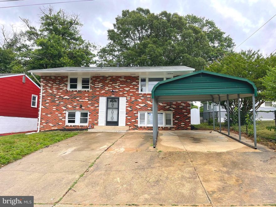 Completely renovated house in Lanham, situated on a large, quiet lot!  Home features a carport and driveway for off street parking.  Main level features an inviting living room with large windows and flows into open dining room & kitchen with updated light fixtures, big island, stainless steel appliances, and durable quartz countertops. The bedrooms are generously sized, with an updated hall bathroom with gorgeous tile shower and vanity.  The fully finished lower level offers  a large rec room, two more bedrooms, full hall bathroom, a bar and laundry area with a  walk-out door leading to the backyard.  The fully fenced rear yard features a deck, mature trees and a storage shed, making it perfect for entertaining.  Located near shopping, restaurants, with public transportation and easy access to commuter routes.
