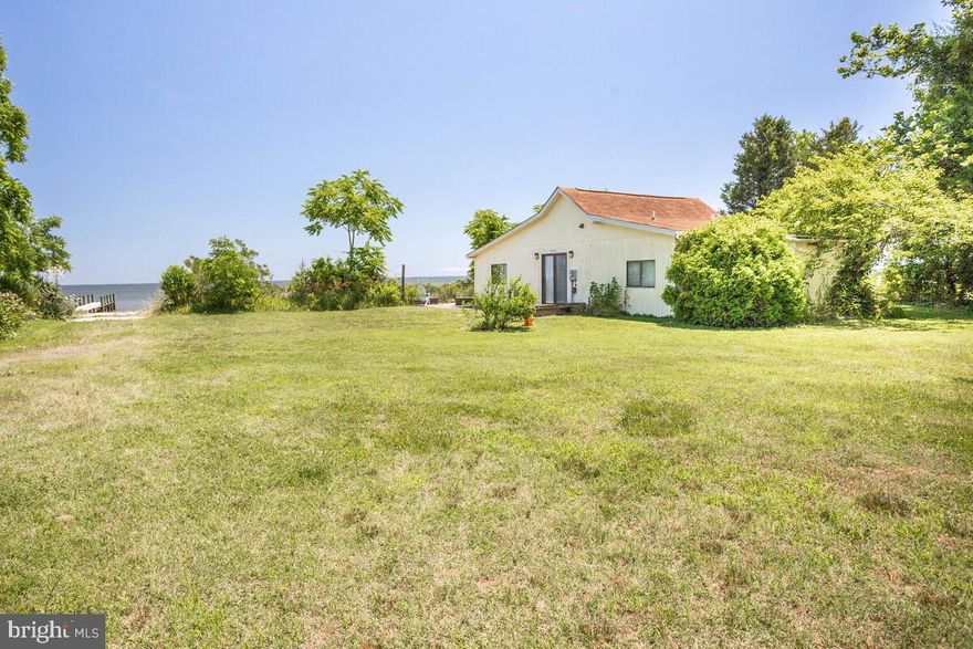 This waterfront cottage located on the Chesapeake Bay offers three bedrooms and two full baths.  There's a full kitchen, breakfast  bar, room for a table and cozy living room with amazing views to the bay.  Set in a condo association consisting of a total of 15 homes, the beach, yard, boat ramp, deck and pier are common grounds.  The association covers lawn mowing, trash pick up, electricity to the shed and pier.  There's a new septic system and there's public water.  This would make a great second home or year round getaway.  Approximately 45 miles to Nationals Park in Washington D.C. Enjoy all that this beach community has to offer.  Pick shark teeth as you take a stroll on the beach, enjoy boating, fishing and crabbing and all that the beach life offers.  There are great restaurants nearby, wineries shopping, hospital, library and more!  Call today to schedule a showing appointment.
