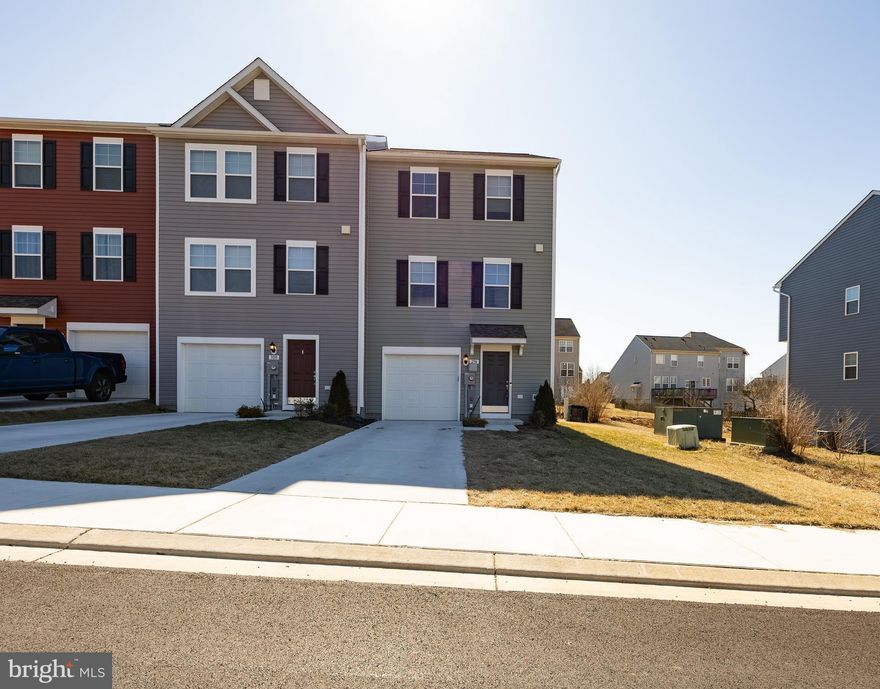 Like new end unit townhouse with mountain and country views.  So close to schools, shopping and interstate access for commuting.  Beautiful kitchen with granite tops and island with overhang for seating.  All appliances are stainless including the gas range.  Primary suite has large walk in closet and full primary bath.  Laundry room is located on bedroom level with the  washer and dryer conveying. The lower level  is unfinished for additional room to expand, and walks out to an expansive rear yard.  Rough in plumbing for future bath.  Extra windows on the side add lots of daylight to this home.  This unit is located near the end of the cul de sac providing lots of privacy and off street parking in addition to concrete driveway and garage.