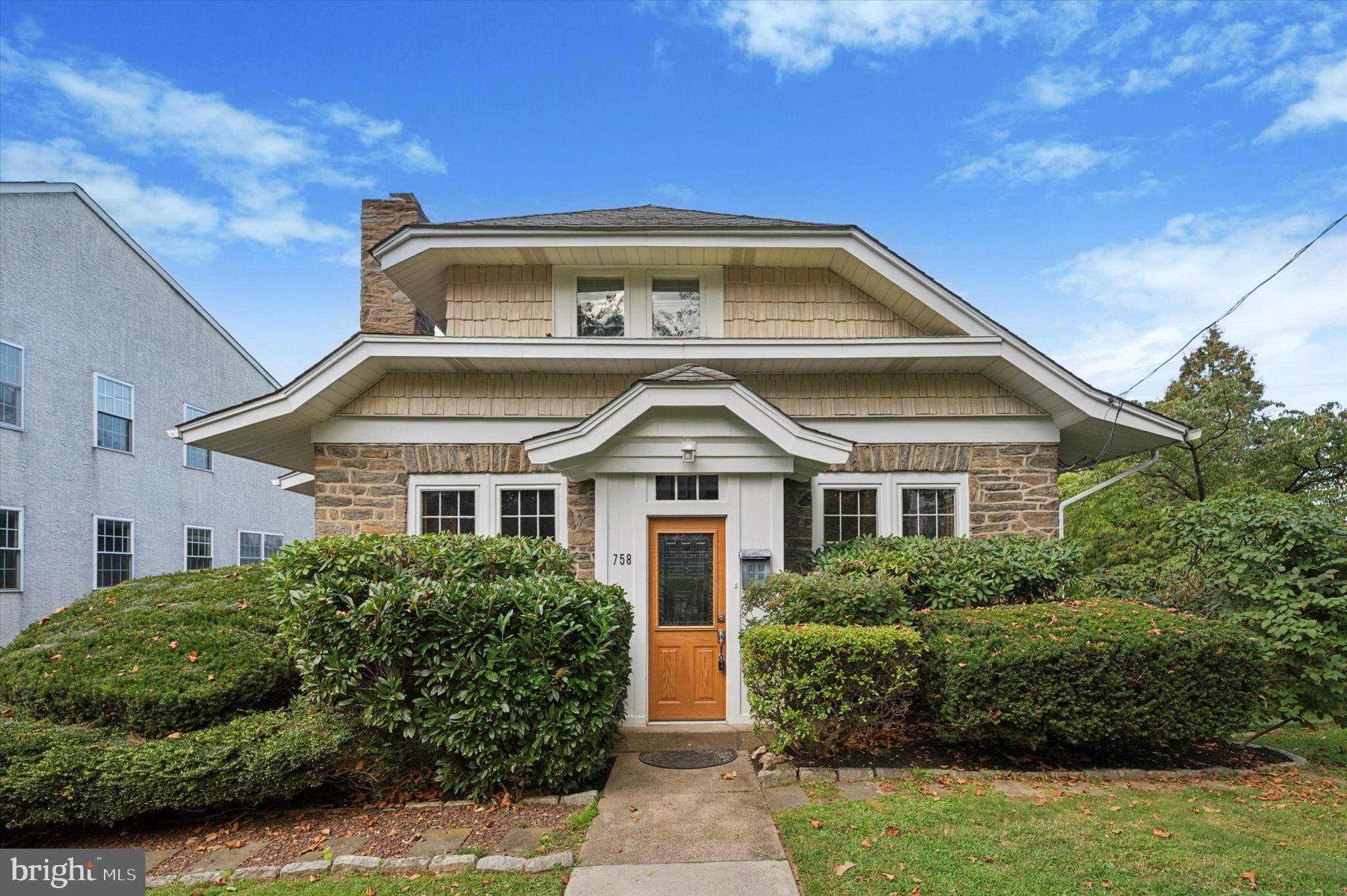Welcome to this beautiful Craftsman home at 758 Lawson Avenue! This attractive architectural style from the early 1900s uses low angled winged roof lines to help it blend into its surroundings, while providing a deceptively large floor plan, with high ceilings and loads of character. While carefully maintained to keep to its original design, this home offers many modern upgrades including renovated bathrooms, dual zone central air, a new gas boiler, a finished walkout basement with full bath and more! Situated on a tree and sidewalk lined street in the Penfield neighborhood of Havertown, this stone home sits on a wider lot of 75 feet, giving the property plenty of space for the private driveway on the left and a great side yard to the right. Walking up, you’ll enter a vestibule (with room for your outdoor gear) before stepping up into an expansive living room that presents incredible millwork including a beamed ceiling and wainscoting along the walls. The living room, big enough to offer two living spaces, also offers a stone wood burning fireplace, deep window sills, and custom plantation style blinds. From the living room, you'll begin to understand the depth of the floor plan as you can either head down the large center hall or over to the formal dining room with painted wainscoting millwork and large bay window. The center hall includes a large open staircase, as well as leads you to the 1st floor bedroom, a full hall bath with tub and travertine stone surround, and a nice size den, surrounded by three walls of windows. The eat-in-kitchen, accessed by both the hall and dining room presents a center island, cherry cabinetry, granite countertops, travertine backsplash, and commercial grade appliances, including built-in Sub-Zero refrigerator, Thermador double oven, a Wolf gas cooktop and stainless steel dishwasher. A door off the back of the kitchen exits to a large rear raised deck that over looks the rear yard and valley beyond. Heading upstairs, the first landing includes a window seat, a large storage closet and the 2nd floor full bath, renovated with beautiful stone tile, large stall shower with frameless glass door and skylight, brightening the space with natural light. The hallway continues to 3 good sized bedrooms including a primary with multiple closets and secondary bedroom with built in bookshelves and skylight. Back downstairs, stairs off the kitchen lead down to a beautifully finished walk out lower level with large living room, with full length windows, custom built in storage, a Eurocave Wine Cooler, new full bath with stall shower, an open laundry area with brick style flooring, and a large storage room, housing the new gas boiler and providing great storage space. An exterior door leads out to the driveway and yard, as well as to the attached garage, accessed through carriage style doors. This elongated garage space runs 40 ft deep, giving room for not just a car but plenty of storage & flex space. Outside, the landscaped yard offers nice privacy and space to enjoy and garden. Located just a half block from the Penfield stop of the Norristown High Speed Trolley Line, access to Philly and the Main Line couldn’t be easier. This home sits just minutes from walking trails along Karakung Drive, parks (The Grange, Powder Mill Valley Park, Wynnewood Valley Park), shops and restaurants at both Brookline Blvd and Edgewood Road. Additionally, this property is in the Haverford Township School District and part of newly renovated Chatham Park Elementary School. If you love character and style, this is an opportunity you won’t want to miss!