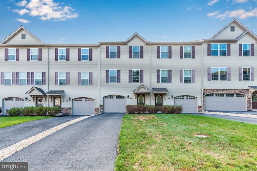 This perfectly located townhome in the Weatherstone neighborhood is located minutes from I-83 and the PA Turnpike. While close to major routes, the home still has a nice quiet setting nestled on a hillside with sweeping views and towering trees. The main level features an open layout with a bright kitchen with granite countertops, upgraded light fixtures and a center island with access to the deck. The large living room is adjacent to the kitchen and feels large and spacious. The upper level houses three bedrooms, 2 full baths and the laundry area - seller to include the washer and dryer.  The entry level with its oversized garage has a large utility room with an epoxy floor just waiting to be finished into additional living space.