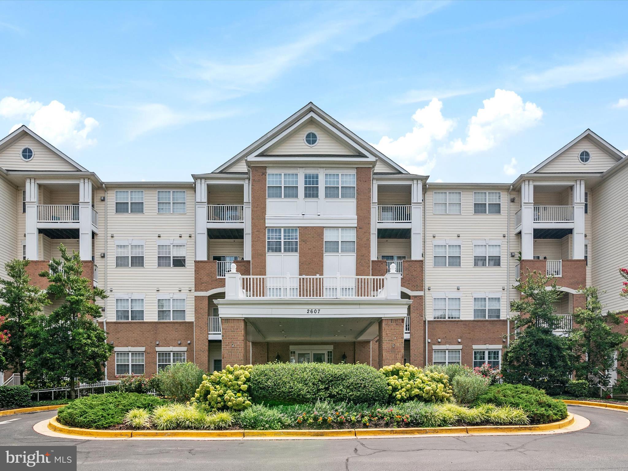 Fabulous 2 BR, 2 FB ground-level unit in the sought-after Waugh Chapel active adult community! This move-in ready home features a spacious, open floor plan with a gas fireplace, updated kitchen with stainless steel appliances and quartz counters, and new luxury vinyl plank flooring. The primary suite includes a walk-in closet and ensuite bath. Enjoy the private patio, in-unit washer/dryer, and fresh paint throughout. One assigned garage space (#10) and separate storage unit (#18) included. Community amenities include secure building access, walking paths around the pond, and easy access to the Waugh Chapel shopping center with grocery stores, restaurants, and more. Pets allowed with restrictions. A true gem!