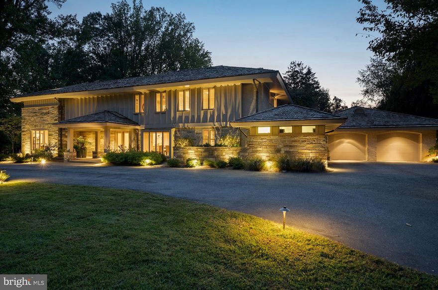 This luxurious custom contemporary home has been renovated to perfection and has two additional buildings on its manicured acre-plus grounds. A guest house, pool, pool house, stone patio, outdoor kitchen and lovely gardens complement the sparkling 7,000 square foot residence.  Carefully upgraded and appointed by its designer-owner, this is a dream home for indoor and outdoor entertaining and living in total comfort. A large circular driveway and portico welcome guests to the home. Outstanding features include an easy flow, lofty ceilings, fine wood floors, large windows offering views of trees and greenery, large walls accented with fine art work, fine trim work and designer fixtures. Three fully finished levels offer six Bedrooms all with ensuite baths, six Full Baths, and two Half Baths. The gorgeous Dining Room accommodates large-scale dining. The renovated Kitchen is a delight with plentiful white cabinetry, upscale stainless steel appliances and backsplash, and designer lighting.  A service entry from the two-car garage leads to the Kitchen via a service area with closets and an extra-large laundry room.  A main level Office with built-ins can serve as a den or guest bedroom, with ensuite bath. The large Breakfast Room opens to the patio through glass doors. A Family Room with stone fireplace and bar has patio access. The spacious Owner's Suite has a Sitting Room and Bedroom opening to a large terrace, a luxurious Owner's Bath and an exceptional walk-in closet. There are three additional large Bedrooms on the upper level, with walk-in closets and ensuite Baths. The fully finished lower level provides a luxurious world of its own, with Guest Bedroom, luxury Bath with sauna, fully equipped Media Room, large Family Room, Exercise Room and large storage areas. Outdoors, the built-in grill area makes outdoor entertaining a breeze. The guest house offers an additional Bedroom, Full Bath, Kitchenette and sauna. The pool house offers a large screened porch with bubbling hot tub. The grounds offer a quiet retreat with room to entertain, dine, relax, swim and enjoy the outdoors in perfect privacy. Every inch of this property displays the owners' extensive improvements and impeccable taste.