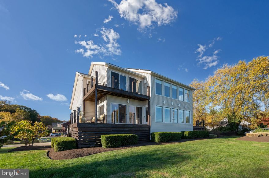 Sophistication and luxury magically merge in this truly one-of-a-kind property offering sweeping views of the Chesapeake Bay. Sitting tall on a pristinely maintained and highly coveted corner lot, at the end of the bayside road, the Colonial-inspired estate is tailor-made for the lifestyle of your dreams. Taking advantage of the exquisite waterfront setting of the home, the thoughtful interior boasts water views from every room, including a two-story great room offering a stately pellet fireplace and panoramic window views from floor to ceiling. Light gracefully flows across hardwood floors and expertly crafted surfaces highlighting the open concept interior, ideal for gatherings big or small. The renovated kitchen is appointed with a Jenn-Air Cooktop and grill, a wall oven, granite countertops, a breakfast bar, a pantry and stylish stone backsplash. Two sizable bedrooms with en-suite, dual entry bathrooms await on the main level while a primary suite on the upper level presents lavish amenities. Stargaze from your private, water-front balcony and enjoy the convenience of a walk-in closet with an added bonus room, along with a luxuriously appointed primary bath showcasing a jetted soaking tub, double-headed shower and dual vanity. An airy loft, overlooking the bay and the great room fireplace, makes for an ideal office or relaxing meditation room while the lower level further highlights sprawling entertainment spaces. Designed with a wet bar and walk-up stairs to the fully-fenced backyard, the recreation room offers endless possibilities. A spacious den, ideal for a crafting or workout room, along with a fifth full bath and full laundry room completes the lower level. Organic design, in harmony with nature, provides an effortless transition from the indoors to the outdoors. Bask in the serenity from one of the three outdoor entertaining spaces, or revel in the four seasons from your backyard or the quiet beach across the street. As a resident, take full advantage of the community amenities including the marina and boat ramp, Sandy Beach and Beverly Triton Nature Park. Convenient commuter routes MD-214, MD-2 offer easy access to Annapolis, the Eastern Bay and Washington D.C. while local shopping, dining and entertainment awaits you only minutes away. Indulge your imagination in “what could be” when paradise becomes home. 

Updates Include the Following: 2014 Roof, 2017 Solar Panels, 2017 Re-Developed Well with 2 Horsepower Pump and Constant Velocity System, 2017 Macerator for Sewer, 2021 50g Water Heater, 2019 Bathrooms Remodeled (4 out of the 5), 2013 Category 3 Hurricane Siding, 2017 Addition off the Kitchen Added to the Home, Professional Landscaping, and more!

Proven income generator if interested in short term rentals or B&B.  First Showings beginning Saturday 11/13/21 at 11:00 am