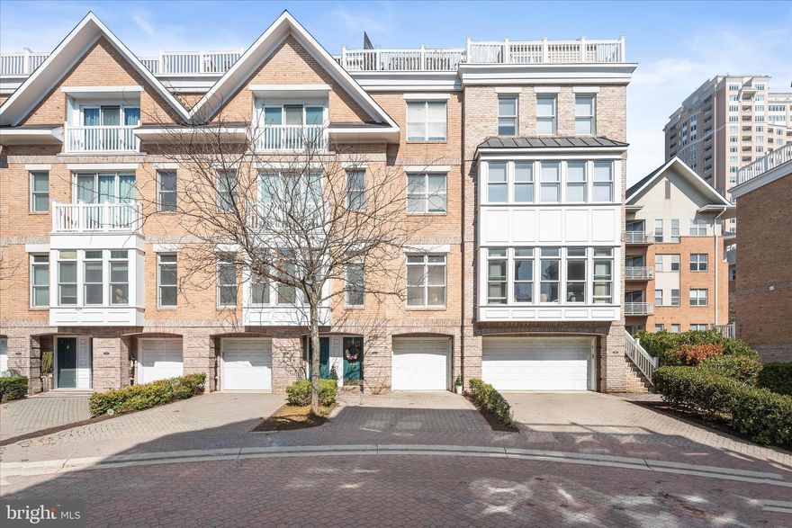 Introducing this exquisite four-level home in the sought-after Harborview community offering three bedrooms, three and a half bathrooms, a rooftop terrace, garage and so much more. This stunning home boasts exceptional details with modern finishes and every space is bathed in natural light with tall ceilings and rich hardwood floors. The interior is graced a freshly painted neutral color, complemented by sophisticated custom trim throughout and upgraded lighting fixtures including Waterford Crystal chandeliers and LED recessed lighting. Step inside where the elegant foyer showcases iron balusters in the staircase that continue through each level. The entry level includes a bedroom suite with a sliding pocket door to an ensuite bathroom featuring marble tile and a walk-in shower. The bedroom also has access outside to a fenced backyard with a paver stone patio. Upstairs, the redesigned main level showcases an open concept design, perfect for modern living. Prepare your favorite meals in the remodeled kitchen that is equipped with stainless steel appliances, 42-inch cabinets with undermount lighting, quartz countertops, a tile backsplash, and a sleek waterfall island with seating. Sliding glass doors in the kitchen open outside to a balcony, perfect for grilling or dining al-fresco. The spacious dining area can accommodate gatherings of any size, while the living room provides a cozy spot to kick up your feet. Finishing the main level is a half bathroom. Ascend upstairs where the lavish primary bedroom suite awaits, complete with a sitting area and a secondary closet. The luxurious en-suite bathroom boasts marble tile with a heated floor, a dual-sink vanity, a freestanding soaking tub, a Starphire Ultra-Clear glass walk-in shower, and a massive walk-in closet with a custom California Closets system. Also located on this level is laundry and a storage closet in the hallway. Up one more flight, the top level includes a third bedroom and third full bathroom that is ideal for guests. A spacious family room on this level is made for indoor entertaining or lounging, complete with a wet bar. A staircase leads up to the expansive rooftop terrace with remarkable views of the Inner Harbor, marina and the city skyline. Host get-togethers, lounge, enjoy Fourth of July fireworks and more, all while enjoying this incredible outdoor space. The desirable Harborview community offers spectacular resort-style living with a wealth of amenities including 24/7 security, pools, fitness centers, snow removal, and meticulously maintained common spaces. Explore the walking paths along the waterfront harbor promenade, award-winning restaurants, marinas, fountains, and all that this fantastic neighborhood has to offer. Additional recent updates include dual-zoned HVAC systems with smart home thermostats, along with a roof that is currently under warranty. Other highlights include an ADT security alarm system with cameras and two water heaters.