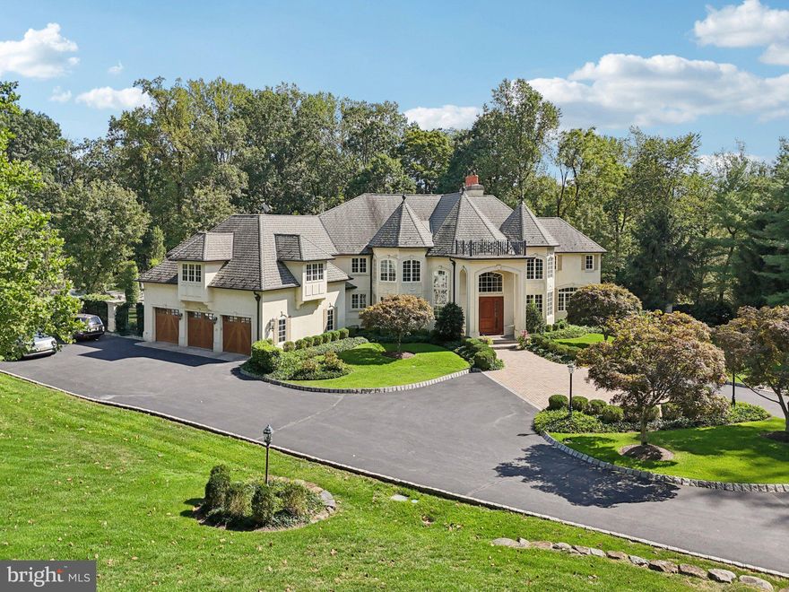 A Landmark Estate in Princeton: Set on 4.5 pristine acres bordering 100 acres of preserved woodland, 13 Hageman Road is a French Normandy–style masterpiece. Gated, landscaped, and timelessly designed, it offers private resort-style living with terraces, gardens, and a stunning pool retreat in one of Princeton’s most sought-after neighborhoods. Beyond a gated entrance, a circular Belgian block-lined driveway introduces the home, gracefully leading to the stately front façade and a side-entry three-car garage. Inside, the dramatic two-story foyer unfolds with soaring ceilings and a sweeping curved staircase. From here, the eye is drawn straight through to the magnificent two-story great room, where a wall of bay windows frames panoramic views of the stunning grounds. Throughout the home, refined details abound—gleaming hardwood floors, intricate mouldings, custom window treatments, and hand-selected light fixtures elevate every space. The formal living room, flooded with natural light from three exposures, offers an ideal setting for a grand piano or intimate conversation. Across the foyer, the dining room stands elegantly behind architectural columns, perfectly suited for gatherings both formal and relaxed. A richly panelled mahogany library—complete with gas fireplace, French doors, and a balcony—sets the stage for work, reading, or quiet reflection. At the heart of the home, the chef’s kitchen combines beauty and function with a Viking Tuscany series six-burner gas range, SubZero refrigerator, Miele dishwasher, and expansive granite island with seating. French doors open to the bluestone patio, seamlessly extending the living space outdoors. Upstairs, the primary suite is a sanctuary, entered through double doors to reveal a fireplace, private balcony, dual walk-in closets, a sitting room, and a sumptuous marble bath with jetted tub and separate shower. Three additional en suite bedrooms and a spacious, recently remodelled study—complete with built-ins and balcony access—offer comfort and versatility. The  finished lower level, just  8 years young, was designed with entertaining and relaxation in mind. At its heart is a mahogany bar with stained-glass accents, a tin ceiling, and full appointments similar to the Waldorf Astoria —including a sink, ice maker, dishwasher and beverage fridge. Just beyond, the adjoining game room offers plenty of space for recreation and outside access to the professionally landscaped patio area. A media room with a raised-hearth stone fireplace, built-in bookcases, and a full wall of windows overlooking the patio and backyard provides an elegant yet comfortable setting for gatherings. A well-equipped gym and a gorgeous full bath complete this level, ensuring it is as functional as it is inviting. Outdoors, the property is a natural masterpiece by Princeton Land Design. Expansive bluestone patios, a gazebo, fountain, and an in-ground pool with separate spa are thoughtfully integrated into a landscape defined by massive boulders, mature trees, and manicured lawns. Backing to Woodfield Preserve, the grounds offer both serenity and privacy, with a fully deer-fenced yard creating the feel of your own secluded retreat. 13 Hageman Lane is a statement of timeless elegance and modern luxury in one of Princeton’s most beautiful settings, close to some of the area’s finest private schools and a short drive to downtown Princeton and the University.  Size is approximate; buyer to rely on their own due diligence.