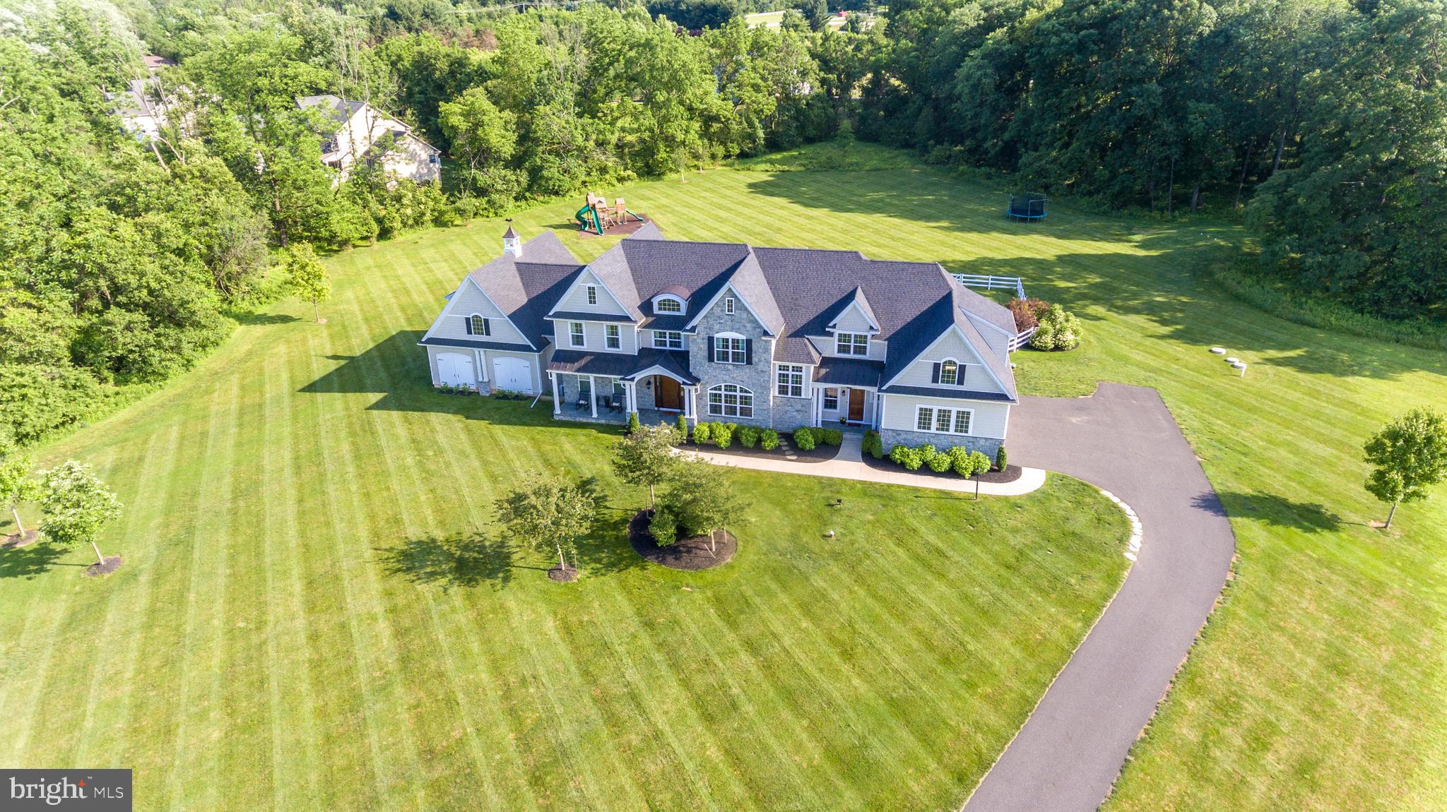 Magnificent Must-See Four Year Old Farmhouse-Style Turn-Key Custom-Built Home Sitting On Almost Six Idyllic Acres in Worcester Township, Just Minutes Away From Blue Bell Shopping And Restaurants. Sports Enthusiast's Paradise Inside And Outside For All Seasons With Indoor Basketball Court, In ground Saltwater Pool And Almost Six Acres Ideal For Outdoor Recreation. The Charming Slate Front Porch And Handsome Estate-Style Front Door Welcome You To Enter The Front-To-Back, Sunlit Foyer With Turned Staircase And French Doors to Backyard. Custom Details Throughout Much Of the Home Include Extra-Large Trim and Millwork, Numerous Transom and Palladian Windows, Many Arched Doorways, Three Sets Of Sliding Barn Doors As Well As 10 Foot Ceilings On The First Floor. The Details Are Endless. The Backyard Oasis With Inground Pool and Outdoor Covered Screened-In Cabana Including A Stunning Built-In Floor-to-Ceiling Stone Wood-Burning Fireplace With Artisan Wood Mantel Are Where You Will Spend Time All Seasons Of The Year With Family And Friends. The Center Of The Home Is The Very Large Open-Concept Family Room And Gourmet Kitchen. The Kitchen Is a Chef's Kitchen With Century Cream-Colored Cabinets, White Apron Farm Sink, Black Honed-Granite Counters, Pot Filler, Walk-In Pantry, Large Center Island With Seating, Cozy Built-In Bench, And Handsome Pendant Lighting, All Stainless Steel Appliances Including Thermador Six-Burner Gas Cooktop, Double Wall Oven Including Convection, Professional-Sized Built-In Refrigerator And Under-Cabinet Microwave. Adjoining Butler's Pantry and Wine Room Make Entertaining A Breeze. Breakfast Room With Vaulted Ceiling Has Arched Opening To Family Room And French Doors To Back Trex Deck. Open-Concept Family Room Has Beamed Ceiling And Floor-to-Ceiling Stone Gas Fireplace With Artisan Wood Mantel. Handsome Sliding Barn Doors Lead To Sophisticated Dining Room With Tray Ceiling, Wainscoting And Gracious Picture Window Where You Will Enjoy Lovely Dinner Parties And Holiday Gatherings. Across The Foyer Is The Handsome Library With French Doors Leading To The Second Of Two First Floor Powder Rooms And Extra-Large Playroom With Storage Closet And Reading Nook. Playroom Could Be Converted To Living Room Or Could Be Used As An Au-Pair Or In-Law Suite. The Second Floor Has A Gorgeous Center Hall Overlooking Staircase. There are Four Well-Sized Secondary Bedrooms Upstairs Including One Princess Ensuite Bedroom With Own Bath And A Hall Bathroom. The Outstanding Master Bedroom Suite Has White Sliding Barn Doors To The Master Bathroom With Soaking Tub, Palladian Window, Stall Shower, Quartz Counter Vanity With Two Sinks, All Styled With Today In Mind And With His And Hers Separate Walk-In Closets And Dressing Areas. The Master Bedroom Has A Tray Ceiling And Small Sitting Area Along With Palladian Windows With Vistas Of The Countryside. Large Upstairs Laundry Room Is Located Near Backstairs To The First Floor Family Entrance. The Very Large Mudroom Including Built-In Cubbies And Powder Room Lead To Three-Car Garage. Separate Charming Front Slate Porch Entrance To Mudroom Makes Everyday Living Easy.Finished Walkout Basement Includes Wet Bar With Shelving, Movie Room, Full Bathroom, Fitness Room, Game Room (Could Be A Sixth Bedroom) As Well As Indoor Basketball Court (Approximate Cost of Indoor Basketball Court $200K). The Indoor Basketball Court Could Also Be Used As Additional Living Space Or Storage. Home Has a Whole-House Generator, Nest Lighting, And Home Audio System. There Have Been Over $150k in Recent Exterior Improvements Including In-Ground Pool, Landscaping, Driveway Extension, And Outdoor Play And Entertainment Equipment.This Gorgeous Home Styled In Today's Standards With Endless Amenities Is Convenient to Recently Updated Blue Bell And Other Area Shopping And Restaurants And Located In Methacton School District. This Home Is A Must-See!