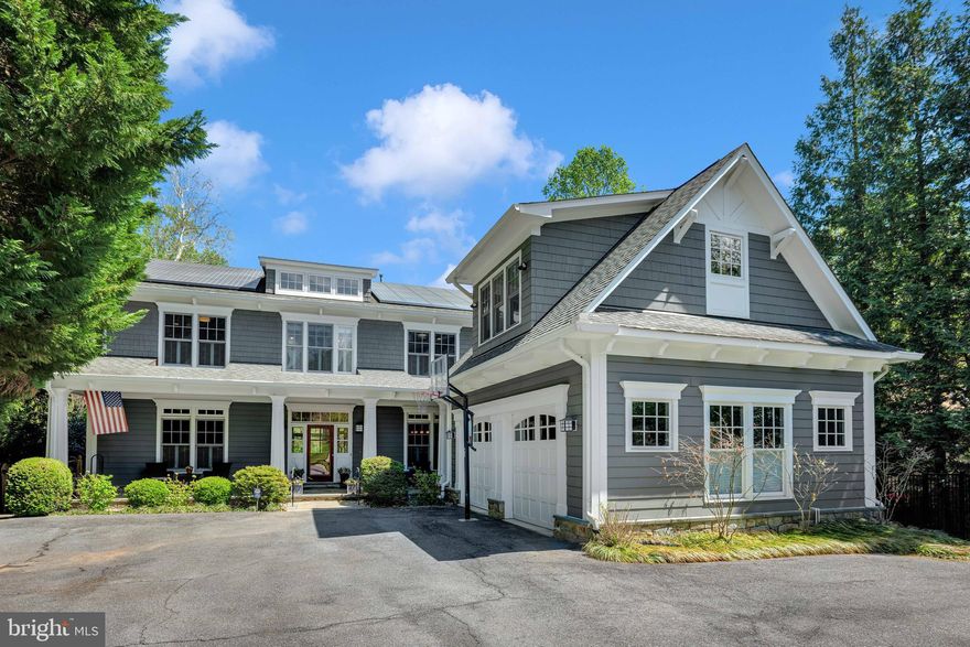 Set on a phenomenal 0.51-acre lot in Bethesda’s desirable Kenwood Park neighborhood, 6525 Kenhill Road is an exceptional Craftsman-style estate custom-built in 2002 by the premier Sandy Spring Builders. Offering 9,000 square feet of finished living space across three levels, the residence features a private backyard oasis with a large heated pool and professional putting green. The home is characterized by tall ceilings, thoughtful architectural details, and modern sustainability features including a whole-house generator and solar panels. Located in the Whitman High School cluster and conveniently close to a number of private schools, the property provides a private suburban sanctuary just minutes from the heart of downtown Bethesda.

An expansive covered front porch leads into a grand foyer, flanked by formal living and dining rooms. The living room features a gas fireplace, while the family room serves as a comfortable central hub with coffered ceilings, custom built-ins, and a second gas fireplace. The large island kitchen and breakfast room flow naturally into the home’s diverse outdoor living spaces, including a screened porch and a massive flagstone patio designed for large-scale entertaining. The main level also provides a private office, a butler’s pantry, and a highly functional mudroom with a secondary laundry set and side entry. For added accessibility, a modern elevator serves all three levels, though it was designed to be easily removed if the original floor plan is preferred.

The upper level is anchored by a primary suite that overlooks the private grounds through a wall of windows. This retreat features its own gas fireplace, two large walk-in closets with custom systems, and a spacious bathroom with dual vanities. Three additional large bedrooms—one en-suite and two sharing a Jack-and-Jill bath—join a second dedicated home office and a large laundry room on this floor. Above the garage, a separately accessed fifth bedroom with vaulted ceilings and a half bath provides a private space for guests or staff.

The lower level is a true entertainment and wellness hub, housing a vast recreation room, a media or billiards area, and a designated space for a home gym. This level also includes a sixth bedroom, a full bath, and a generous storage room with outside access. Other notable amenities include a cedar closet for seasonal storage and a comprehensive irrigation system. The exterior is equally impressive, with the heated pool and deck surrounded by mature landscaping, custom lighting, and a flat grassy area, while the private driveway and two-car garage provide ample parking for residents and guests alike.