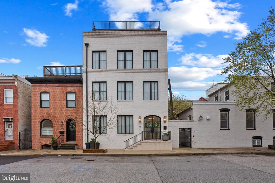 Exceptional and Rare Custom Built Baltimore City Town home with Unmatched Views!  Discover a one-of-a-kind urban retreat offering over 6,000 sq ft of luxurious living space with breathtaking city and water views.  This extraordinary residence seamlessly blends elegance, space, and convenience in an unparalleled location.  

This home offers 6 bedrooms, 6 full bathrooms and 2 half baths, theatre room, office, entry level mudroom with laundry.  The second floor has 3 large bedrooms, 3 full baths and a well-equipped laundry room.  Take the oversized elevator to the third floor which features a stunning open-concept kitchen and living room, perfect for both everyday living and entertaining.  The gourmet chef's kitchen is outfitted with high-end wolfe and subzero appliances, elegant soapstone and quartzite countertops and custom cabinetry.  A well designed butler's pantry helps with prep and storage.  The spacious living area offers a cozy gas fireplace, custom built-ins and an abundance of natural light.

The  luxurious 4th floor primary suite offers a private retreat, featuring spacious sitting room with a wet bar and half bath - ideal for relaxing or entertaining.  The suite offers a stunning marble-clad primary bathroom with high-end finishes and spa-like amenities.  A private staircase provides direct access to the expansive rooftop deck with incredible views of downtown and the water.

Built with the highest quality materials including spray foam and rockwool sound proof insulation, white oak herringbone flooring, 8 foot solid core doors, custom inlaid wood cabinetry with mahogany drawers, 2 separate carrier HVAC gas units with 4 zones, 2 separate on demand gas water heaters.   Full home theatre and audio throughout with security cameras and in-wall Ipads installed on every level for convenient access.  Full home water filtration system, 3 laundry rooms, heated floors in every bathroom and mudroom, automatic custom curtains and roller shades.

Private, fully secluded rear patio has a wood burning fireplace and built-in pizza oven.  Relax and watch tv under the cafe lights in your own outdoor city oasis.

The detached 2-car garage is fully finished with granite garage flooring and full of extra closet and storage space.  The separate rear entrance provides private access to the 2 bedroom apartment with a full bathroom and laundry.  Perfect for an in-law suite, au pair or air bnb for extra income.  The home is located in a prime location - steps to the waterfront and all the top dining and shopping that the city has to offer.