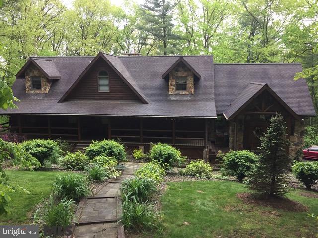 This home will wow you the minute you walk through the door. A beautiful log home nestled on a secluded lot in Shenecoy Manor, minutes to town, shopping, and Raystown Lake. The perfect home away from home or your forever home. As you walk through the door you enter a large great room with cathedral beam ceiling & wet bar. Kitchen has Stainless steel appliances, granite counter tops and open concept to the living, great room, and dining area. Enjoy the convenience of a First floor master suite. Mother-in-law suite or guest quarters on lower level with family room, bedroom, full bath, game area, and also plumbed for a future kitchen area, utility area w/work bench and large laundry room. The deck spans the back of the home and gives the feel of being in a tree house surrounded by nature.
