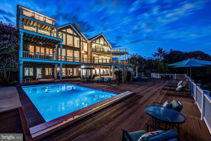 One-of-a-kind city and monument views from this custom-built home in the coveted Arlington Ridge neighborhood.  Offering over 13,000 square feet and featuring 7 bedrooms, 8 full bathrooms, 3 half baths, numerous decks off each level and a spacious terrace with pool.  

An entertainer’s dream, the main level boasts an open, flowing floor plan and offers a wall of windows overlooking the expansive deck with dramatic city views. The kitchen boasts commercial-grade appliances (perfect for hosting large parties) dual islands, extensive storage and a walk-in pantry.  The sun-filled family room has a two-story stone wood-burning fireplace.  Just off the kitchen is a comfortable office featuring a two-sided gas fireplace shared with the wood paneled library.

Tucked away behind the garage is a separate area with its own entrance, perfect for a home office, in-law or nanny suite and is complete with two living spaces, bedroom with full bath and powder room.  

Upstairs you’ll find the spacious primary suite with dramatic vaulted ceiling, wall of windows, gas fireplace, spa-like bath, dressing area, large walk-in closet and its own private deck. Four additional bedrooms (all ensuite), teen space, music room with second deck and laundry are also located on this level.  On the top level you’ll find a versatile loft space with full bath, sun-loft with fireplace and city view deck with monument views.

The walk-out lower level has a large recreation room, home gym area, theater, hobby room, climate-controlled wine-room and guest suite.  The large terrace and deck offer numerous seating and dining areas and the beautiful heated pool.   

Arlington Ridge is ideally located for a quick trip downtown, shopping at Pentagon City/Pentagon Row/National Landing and is close to both Amazon HQ2 and Reagan National Airport.