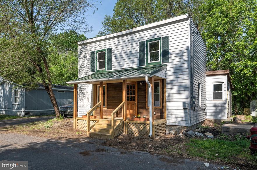 Imagine owning your own piece of Shepherdstown—charming, walkable, and full of character. Just blocks from Shepherd University and downtown, 111 Ray Street is both cozy and incredibly functional. This updated 2-bedroom cottage offers flexible living space and thoughtful design in a compact footprint.
Inside, you’ll find durable luxury vinyl plank flooring, a welcoming living room, and a crisp white kitchen with butcher block counters and plenty of charm. The main-level bedroom is conveniently tucked off the full bath and laundry area—ideal for single-level living if desired. Upstairs, a second bedroom pairs with a bonus living room or studio space, offering options for guests, working from home, or just a little more breathing room.
Out back, a separate bonus room with two exterior entrances and a wood-burning stove adds even more versatility—perfect for a workshop, studio, or creative flex space.
The front porch is made for morning coffee and neighborly chats, while the backyard offers space for a shade garden, relaxing, or entertaining. 
Whether you're searching for your first home, a sweet Shepherdstown retreat, or a smart investment property, this one truly punches above its weight.