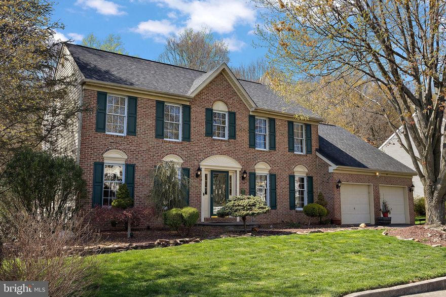 Located in the desirable community of Nonantum Mills and backing to scenic walking paths with reservoir views, this spacious Colonial has been meticulously maintained and thoughtfully updated over the past 20 years. This brick-front home features updated HVAC (2024) and hardwood flooring throughout most of the main level.

A welcoming open foyer is flanked by a formal living room and a generously sized dining room, ideally situated off the kitchen—perfect for gatherings and everyday living. The family room showcases vaulted ceilings, skylights, and a stunning floor-to-ceiling stone gas fireplace, with French doors leading to a bright sunroom featuring cathedral ceilings and sliders to a large deck overlooking the rear yard.

The expansive eat-in kitchen includes a center island and direct access to the elevated deck, creating a seamless indoor-outdoor flow. A main-level laundry room and private first-floor office add to the home’s functionality.

Upstairs, you’ll find four bedrooms, including a spacious primary suite complete with a walk-in closet, separate sitting room, and a full en-suite bath with four-piece layout. Three additional bedrooms offer ample space and versatility.

The finished lower level (41x26) provides exceptional additional living space, featuring luxury vinyl plank flooring, surround sound, a corner gas fireplace, and decorative columns with stacked stone accents. Enhanced with added insulation for soundproofing, this level also includes an updated Andersen slider leading to a paver patio.

Outdoor living is equally impressive, with extensive hardscaping in both the front and rear yards. The beautifully designed paver patio and expansive deck create the perfect setting for entertaining or relaxing while enjoying the peaceful surroundings.