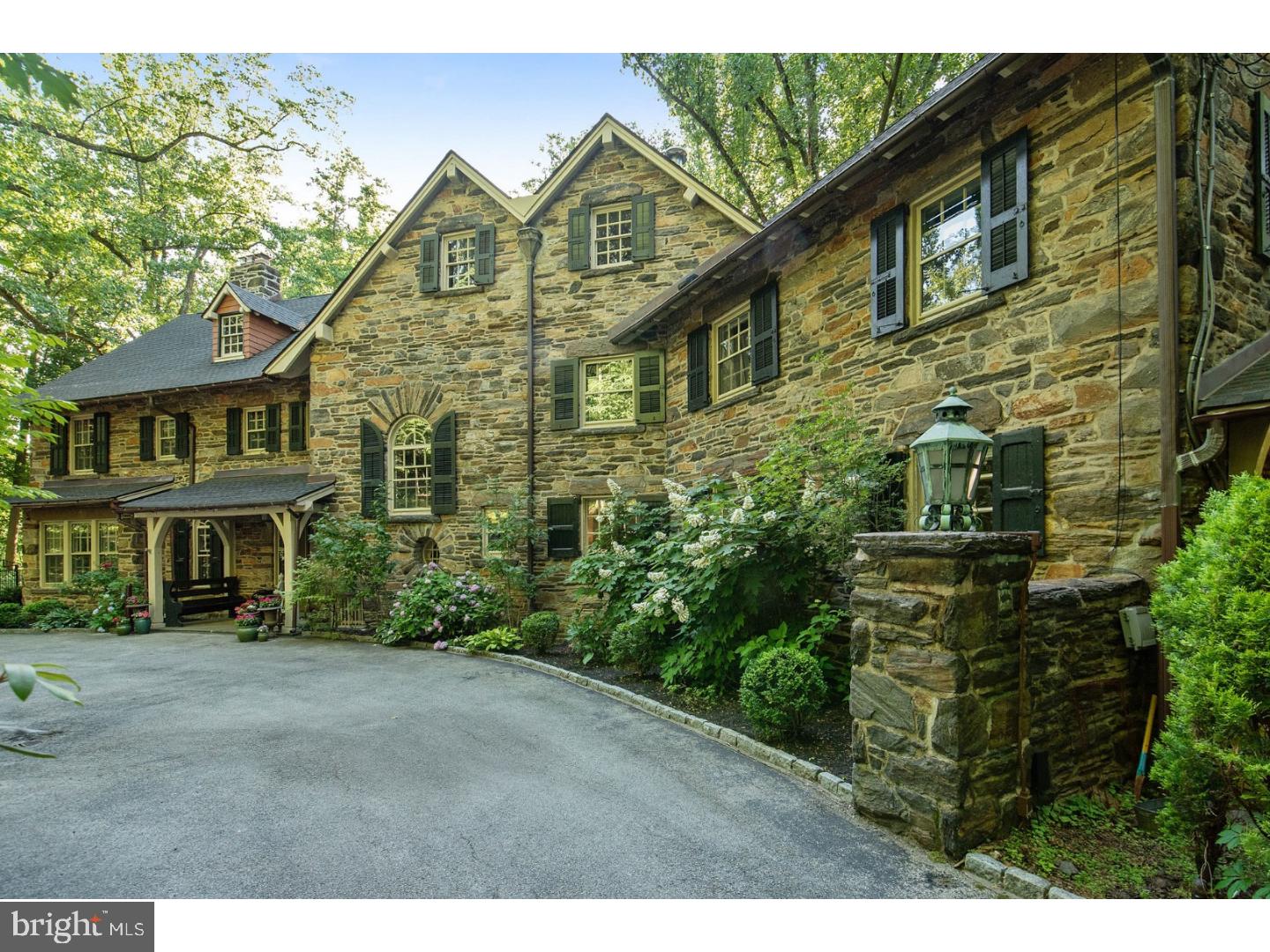 This breathtaking country home estate is set on 2.5 acres and was built in 1904. It was designed by world-renowned Philadelphia architect Wilson Eyre. This phenomenal six bedroom, 5 full bath and 1 powder room, 7006 sq. ft. stone home incorporates a lovely mix of old-world charm and modern conveniences including the solid architectural structuring and intricate wood detailing found in luxury early 20th century estates. On the first floor, you'll find extraordinary living and dining rooms, each with its own fireplaces and an impressive reception hall, a library with plenty of bookcases and a fireplace. The full kitchen boasts granite counter tops, Brookhaven cabinetry and stainless steel appliances with a jaw-dropping adjacent breakfast room featuring exposed stone walls and large beautifully arched windows. Extended from the kitchen is the open family room with wet bar, gas fireplace and custom cabinetry. On the upper levels, you'll find four spacious bedrooms, one with a balcony and fireplace, and two full shared bathrooms and the master suite boasting separate dual bathrooms, a fireplace and separate sitting rooms. Additionally, the estate includes a walk-out finished lower level, entered through stone entrance piers, offering a large recreation room, a full bath, a gym and a laundry room. The serene grounds, surrounded by trees for ultimate privacy and seclusion, also features a walled courtyard, extensive wood deck and large inground heated pool. The location is second to none, a stone throw away from Suburban square shopping and the Mill Creek dog park and within the award winning Lower Merion school district. Enjoy the best of the Main Line just steps away! You don't want to miss this once-in-a-lifetime gem of home so make your appointment today!