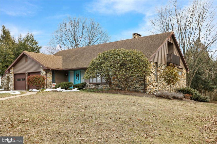 Contemporary Wyo Hills Cape with Expansive Walkout Retreat     

On one of Wyomissing Hills’ most admired streets, you’ll find a beautiful, contemporary cape with striking stone exterior, “wave-to-your-neighbor” curb appeal, and just enough mature landscaping to feel tucked away without feeling isolated.  

Step through the welcoming front entry, where the foyer is likely to make guests pause for a second just to take it in. The ceiling lifts up above you, the tile is cool and clean, and the open staircase with wood railing pulls your eye both up to the second floor and down toward the walkout lower level.  

To the right is your main living room, anchored by a large bay window that sends light across the space and the easy-crank windows make it simple to let in a breeze.  

Follow the Brazilian cherry hardwood that flows throughout the entire main level and ease right into true one-floor living. The Master Suite stretches along this side of the house, with warm hardwoods, entire walls of closets (five in total), and a marble Master bath that feels like a private spa — with a large, tiled steam shower with a marble bench, soaking claw-foot tub, double vanity with Corian top, dedicated make-up area, and thoughtful built-ins.  

Back in the hallway, you’re drawn into the great room, where stone shelving and a stone feature wall with a gas-ready fireplace and water feature is an easy backdrop for holidays, game days, or everyday living, while a large glass slider extends the living space to the 2020 composite deck, overlooking the flat, private backyard.  

Just off the great room, the open dining area enjoys gorgeous built-in cabinetry, flowing naturally into the kitchen so everyone stays connected during meals and gatherings.  

The kitchen is built for upscale hosting, featuring an island with breakfast bar, stainless appliances with electric cooking, built-in range with double oven, microwave, dishwasher, maple cabinetry, pantry, tile backsplash, built-in desk, and lazy Susan.  

A nearby tile mudroom/laundry area with built-ins and direct access to the side patio and oversized two-car garage with pull-down attic storage, built-in shelving, and a utility sink keeps daily life organized.  

Upstairs, past the landing and two hallway walk-in closets, you’ll find two generous bedrooms with vaulted ceilings, ceiling fans, walk-in closets of their own, and sliders to their own private decks. They share a large Jack & Jill bath with tile flooring, oversized vanity, crank windows, tub/shower, and a roomy linen closet.  

The finished walkout lower level seems endless, opening with a carpeted rec room with built-in cabinetry, a stone-arched gas stove, and a slider to a covered patio — an easy hub for movie nights or game days. An adjacent room can serve as a fourth bedroom, guest space, or hobby room, with nearby storage and a half bath.  

A kitchenette with Honeybrook custom cabinetry and a corner built-in with leaded glass makes this floor ideal for guests or multi-generational living, while a dedicated office with built-in desk creates a quiet, work-from-home spot. An unfinished workshop with ceramic sink, workbench, and French door to the outside rounds out the level with space for projects or extra storage.  

Outside, you can enjoy the seasons from multiple patio areas or the composite deck, while the flat backyard creates a mix of open and more private spaces with pleasant views — ready for summer cookouts, fall firepit nights, or the kids’ playdates.
