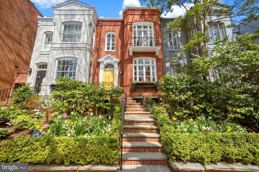 Stunning renovation of this classic 1887 Georgetown townhouse ideally situated in the East Village. Beautifully maintained and expertly updated, this charming 3 Bedroom home offers 2,470 Sq/Ft featuring high ceilings, crown moldings, original stair railings, original wood flooring in Living Room and Upper Level, Italian travertine tile laid in the French/Versailles pattern in the Foyer, Kitchen and Dining Room and original windows/doors throughout. Flooded with natural light, Main Level is perfect for entertaining, including gracious Foyer connecting to Living Room with original windows and wood-burning fireplace and mantle, Hallway with powder room and coat closet leading to gourmet Kitchen with Carrara marble counters, stainless steel appliances, and ample storage. Formal Dining Room with fireplace, beautiful windows and French doors connects seamlessly to deep multi-level Patio/Garden with tons of space for large gatherings, features gorgeous landscaping and convenient gas line hookup for grill. The gorgeous Primary Suite on the Upper Level includes a fireplace, 11.5’ ceilings original windows with Juliette balcony, updated large custom walk-in Closet, and Full Bath, including the convenience of a W/D on the Upper Level.  Recently installed Solar Panels (fully paid for) and Automated Irrigation and Lighting Systems have been installed in front and back yards. THIS IS A MUST SEE!