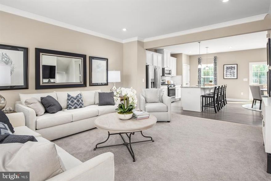 This home is to be built . Welcome to the Mendelssohn, where the convenience of townhome living meets the amenities of a single family home. On the main living level, an enormous kitchen with a large island opens onto a bright and airy living room, perfect for entertaining. Plus, you'll have a conveniently placed powder room. Upstairs are two spacious extra bedrooms with ample closet space and a hall bath. Your primary suite features a tray ceiling, a huge walk-in closet, an ensuite bath with dual vanities, and a large walk-in shower with an optional seat. No matter what you choose, your laundry room is just around the corner with space for a side-by-side washer and dryer. The lower level includes a large 4th bedroom with private full bathroom! You will love your new Mendelssohn home. Bloom Village is Montgomery County's most affordable new home community. Own a garage townhomes with easy access to endless community amenities and location right off I-270, Rt. 355, nearby Crown & Rio, and 30 minutes to DC. Explore this community today! Photos are representative. Lot premiums may apply.