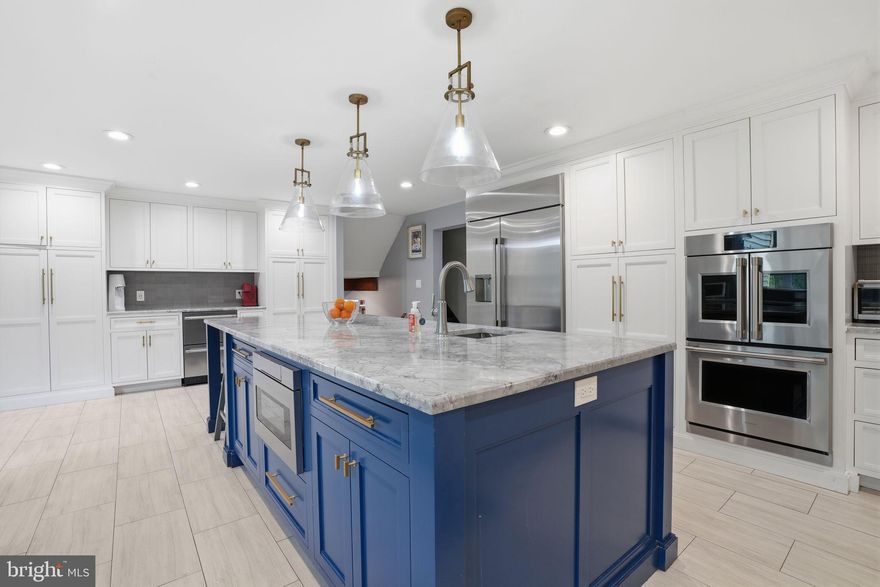 Welcome home to this GORGEOUS 4 bedroom home located in the highly sought-after Sandy Run community of Yardley. Featuring thoughtful upgrades and versatile living space, this home offers the perfect blend of style, comfort and functionality. Step into your welcoming foyer, complete with a built-in organizational system for coats, shoes, and everyday essentials and a convenient powder room. Continue past a mudroom—offering direct garage access and a washer/dryer hookup—to your cozy family room enhanced by exposed beams and anchored by a wood burning fireplace set amongst a stone accent wall. Just beyond, enjoy your bright and spacious sunroom showcasing exposed beams, skylights AND wall-to-wall windows offering panoramic views of your tree-lined backyard! A few steps up, you’ll find your STUNNING gourmet kitchen designed for culinary enthusiasts. A massive island in a striking navy finish is accented by beautiful pendant lighting and features a built-in microwave and prep sink. The kitchen continues to impress with abundant custom cabinetry accented by gold hardware, elegant quartzite countertops, farmhouse sink and a bold designer tile backsplash. Professional-grade stainless steel appliances complete the space, including a Wolf six-burner range with griddle and GE Monogram refrigerator and French door double wall oven—making it a true chef’s dream! A dedicated beverage bar with a GE Monogram double drawer drink refrigerator brings elevated convenience and functionality, while the spacious dining area with sliding glass doors opens seamlessly to your backyard - perfect for indoor/outdoor entertainment! Finishing this level at the front of the home is a spacious formal living room, currently being used as additional dining space.   Continue up another level to four spacious bedrooms, each with ceiling fans and ample natural light. Your luxurious primary suite, recently remodeled to perfection, features a separate flex space ideal for a home office, gym, or sitting area, along with TWO walk-in closets! The luxurious en suite bathroom offers a spa-like retreat complete with stunning patterned tile flooring, dual vanity, standalone soaking tub AND a glass-enclosed rainfall shower with striking floor-to-ceiling tile and built-in bench! The primary suite also includes a dedicated laundry area AND a SECOND full bathroom for added privacy! (The primary bedroom was thoughtfully remodeled to include the expansive primary bathroom, the 2nd bathroom was the original primary bathroom but could easily be re-connected to the large guest bedroom for a full princess suite).   A full hallway bathroom with floor to ceiling tiled tub/shower combo serves the remaining bedrooms.  Back downstairs, the finished basement adds even more living space, including a large family room AND a versatile room perfect for an additional home office or playroom, while an unfinished section provides ample storage.  Step outside to your private backyard, surrounded by mature landscaping that creates a serene and secluded setting. A spacious patio invites you to relax with your morning coffee, unwind at the end of the day, or host gatherings with ease! This home features a two car side entry garage and large driveway for ample parking. Other upgrades include an electric dog fence, NEW roof (2021), NEW HVAC (2021), 2 zone heating, and NEW siding! Walkable to a variety of restaurants and shopping in nearby Yardley Boro AND near Yardley Station offering direct service to Center City, Trenton Mercer Airport AND I 295 for easy commuting! Pennsbury School District too! Don’t miss your opportunity to see this beautiful home today! **Seller is also including a one year home warranty to the future buyer**
