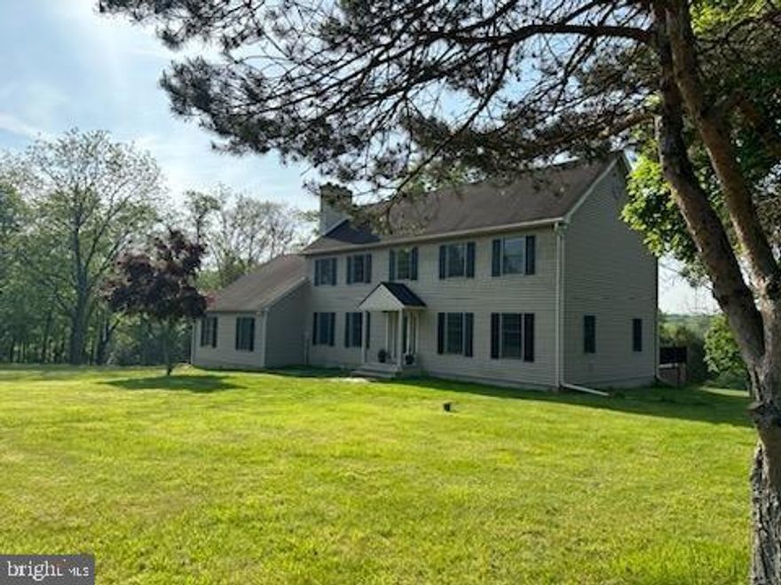 If you are looking for Location and Privacy on 10+ Acres, this is the home that will make your dreams come true! Driving down the long driveway, situated high on the lot, you are greeted with tranquility. The private rear of the home affords a deck overlooking the open landscape surrounded by trees. Sunlight streams into this beautiful four bedroom, two and one half bath home with a first floor Fireplace Room for your cozy quiet time and relaxation. The first floor also has a Formal Living room and Dining room perfect for entertaining your guests. The upgraded kitchen is perfect for gourmet cooking with a huge island and entertainment area. You also have access to the convenient Laundry area and Powder Room. Hardwood floors throughout the first floor. On the 2nd floor, the large Main bedroom features hardwood floor, a beautiful fireplace, a walk-in closet, a private bath with a oversized frameless stall shower, double sink with granite top and cherry vanity, and an oversized linen closet and tile flooring. Three other generous sized bedrooms feature wall to wall carpeting and a shared hall bath.  In addition, the full attic provides space for seasonal storage. The entire house has newer windows and doors.  Your cares will melt away as you take in the sights and sounds of nature at every turn, from the soaring hawks, deer, red fox, wild turkeys roaming in your private retreat. This Dark Hollow Road property offers the privacy of a country home, in a most convenient location. Just 41 miles from Philadelphia, and 76 miles from New York City.