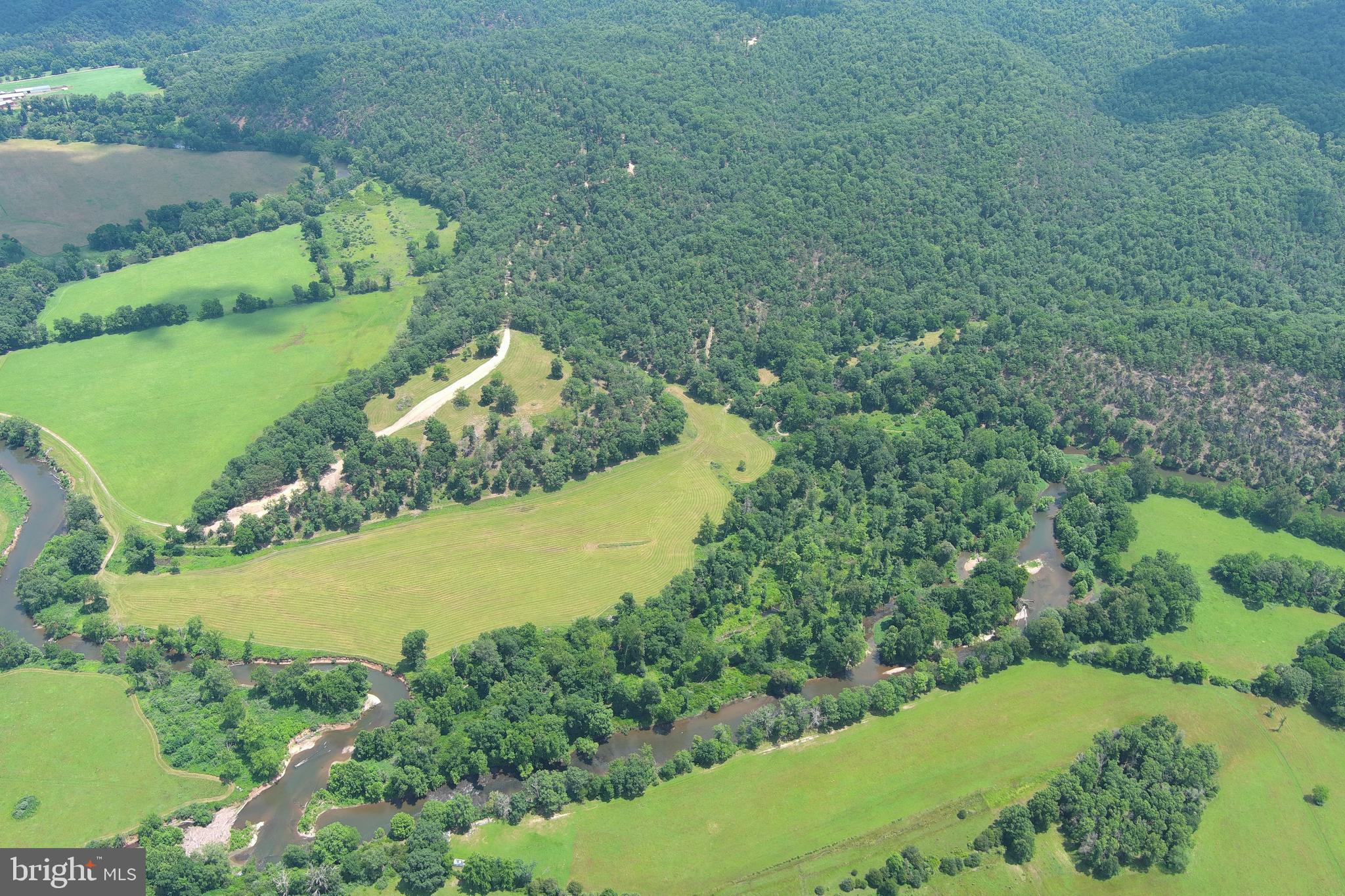 THE BLUEPRINT....IF YOU HAD TO DRAW UP THE PERFECT PROPERTY....IT WOULD LOOK LIKE THIS! 72 ACRES WITH 3278 FT OF FRONTAGE ON WV'S CLEANEST RIVER "THE CACAPON", A BUILDING SITE THAT WILL BLOW YOU AWAY, 17 ACRES OF RIVER BOTTOM PASTURE, 50 ACRES OF WOODS TO HUNT & HIKE AND PRIVACY GALORE. THE BUILD SITE IS ON AN ELEVATED SOUTH FACING KNOLL WITH WORLD CLASS VIEWS OF THE CACAPON VALLEY AND DISTANT MOUNTAINS. THE RIVER IS WILD AND LOADED WITH FISH, DROP IN YOUR KAYAK AND FLOAT DOWN STREAM TO ONE OF SEVERAL PUBLIC ACCESS POINTS. HUNT FOR TROPHY GAME, LONG RANGE SHOOT & ENJOY YOUR ATV'S. UTILIZE THE BOTTOM LAND FOR LIVESTOCK OR CROPS. PARADISE FOUND ONLY 1.5 MILES OFF THE PAVED ROAD.....LESS THAN 15 MINUTES FROM THE THRIVING VILLAGE OF WARDENSVILLE, 35 MINUTES FROM WINCHESTER, VA AND 110 MILES FROM THE WHITE HOUSE! EASY TO GET TO BUT HARD TO FIND, THE DRIVE FROM DC BELTWAY IS A BREEZE. NO HOA AND MINIMAL DEED RESTRICTIONS. THIS IS ONE OF THOSE ONCE IN A LIFETIME PROPERTIES....