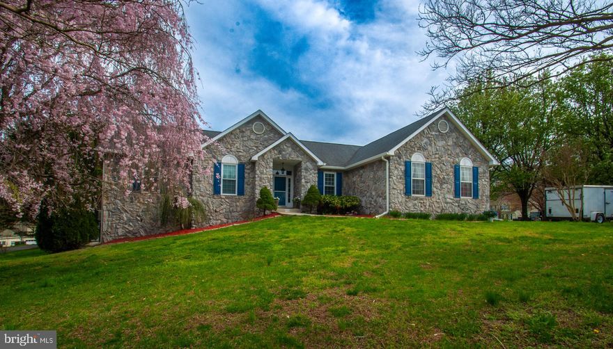 Rare Find in Huntingtown! This spacious custom rambler is a dream for entertaining, featuring soaring ceilings and an inviting sunroom just off the kitchen, drenched in natural light from its wall-to-wall windows. The eat-in kitchen is both stylish and functional, featuring tile flooring, quartz counter-tops and stainless steel appliances. The kitchen leads to an eat in area that offers a bright and airy space for casual meals and also a convenient mudroom/laundry room with garage access. There is a formal dining area for special occasions with hardwood flooring that flows into the great room with its stunning stone fireplace to create a warmth and a cozy ambiance. The main level also features three generously sized bedrooms to include the owners suite with full bath that includes double vanities, separate shower, jacuzzi tub and walk in closet. The open staircase leads to a fully finished basement, complete with a wet bar, stylish tile flooring, recessed lighting, and an extra room—perfect for a home office or guest space. You'll also find a dedicated craft room with ample shelving, a full bath, and french doors leading to the side yard. With two sheds and an abundance of closet space, you’ll have room for everything. Step outside to enjoy the deck off the kitchen, overlooking a fenced-in area—ideal for pets or a play space. Additional highlights include floored attic space, central vacuum, a newer roof (2017), and an upgraded HVAC system (2020) for peace of mind. 
Close to Kings Landing Park with Fishing pier, kayak launch, pool, hiking trails and equestrian facility.  Don’t miss this rare gem—schedule your showing today!