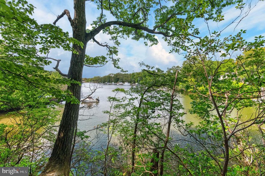 This incredibly private waterfront property along Mill Creek—recently dredged by the county in March 2025—offers a rare and unusual opportunity to purchase two waterfront parcels along with an access lot in a natural, wooded setting just minutes from the Community College. Encompassing well over an acre of land that has not been available for sale in more than 60 years, the property presents endless potential to enjoy as a private waterfront retreat or re-develop into a truly special enclave. Price includes all three lots: (1) Parcel 191, Lot 12 in Divinity Cove Subdivision, an access lot; (2) 243 Haverton Road (Parcel 724) and (3) 245 Haverton Road (Parcel 725), 2 waterfront parcels on Mill Creek with approximately 200 feet of water frontage on 1.3 acres combined.
The existing home at 245 Haverton Road is a distinctive mid-century modern residence with Craftsman and Asian influences, offering a warm blend of natural materials and thoughtful design. The cedar, poplar, and cypress exterior complements the interior spaces. The upper level features a stylish kitchen with cherry cabinets, slate countertops, double sink, under-cabinet lighting, pantry, and casement windows. The primary bedroom includes a full bath and closet, while the second bedroom is served by a hall bath. A washer and dryer are conveniently located on the upper level. The lower level includes one finished room with multiple windows that fill the space with natural light, plus a walk-out workshop with three workbenches, new French doors, and ample space for creative projects. Additional updates include a new hot water heater and some new windows, while the home retains custom lighting and a water conditioner. The property also offers access for the installation of public water and sewer.
The seller is the Personal Representative and makes no representations about the subject sale but prefers to sell all three lots together. Property is being sold as is / where is. Please review the feasibility study conducted by Drum Loyka Engineers, included in the Bright documents, for more information. Do not drive down the property without an appointment. This property is not part of the Twin Harbours HOA.
The Lot Size, Assessed Value, and Taxes listed in MLS reflect the size, assessed value and taxes of all 3 properties. Feasibility study by Drum Lloyka available upon request.