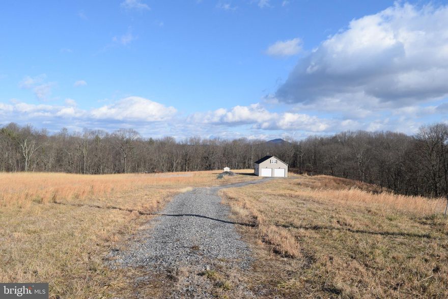 Rare opportunity to own your own 20+ acre WV escape. This garage/cabin is just the start. Hunting, 4-wheeling, hiking, target practice. Approx 5 acres open, the remainder is wooded and has a stream on it. This property is ready for you - electric, well, septic all installed. Solar panels and wood-burning stove are ready to install as well as plumbing/electric  RV hookup pedestal ready to install. Keep it as it is or build a home or a double-wide on the property.  Equipment for Starlink conveys with the property as well as a storage battery and power invertor for the solar panels. The property has ductless heating/A/C "mini-splits" for year-round comfort, a Front loading washer, and a dryer convey. Full bath and kitchenette on the Main Level and an open Upper Level is perfect for living and bedroom.  Security system in place with cameras (audio and visual recording).