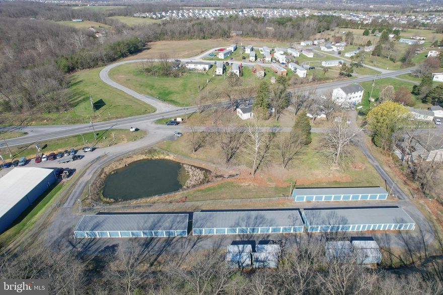 PRIME LOCATION! Ready to own your own business? This is an unbelievable opportunity to immediately cash flow in your business investment.  88 storage units, and 50X100 auto center on nearly 5 acres along State Route 51E between expanding Inwood and Charles Town, WV.   Additional entry/ exit from Cheshire Road. TURNKEY Investment with an existing lease in place for the auto center and fully booked storage units.  Well maintained property with more business opportunity or expansion of existing operations completely possible here. Set your appt today or call to discuss the opportunity!