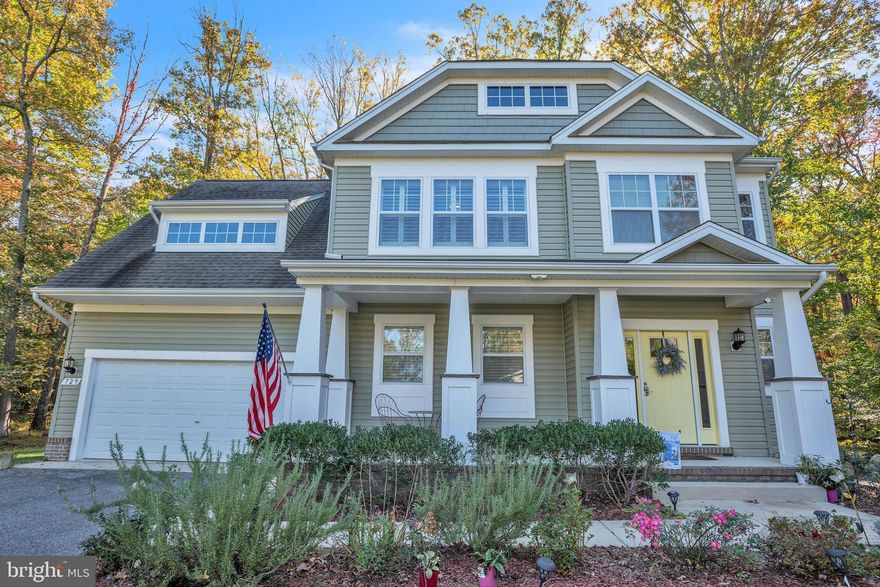 Walk the shoreline along the Chesapeake Bay when you become part of this highly sought after community of Holland Point/North Beach Park. Just one block off the Bay, this craftsman home has so much to offer. A open concept main level features a great room with gas fireplace . The kitchen with its granite countertops, upgraded cabinetry, gas stove, and raised countertop/bar is the perfect gathering spot. Also on the main level is a powder room and the mud room/laundry area. The screened porch overlooking the private, wooded backyard will no doubt be a favorite extended living area. The primary bedroom on the upper level has a deep tray ceiling making it feel extra spacious. There is a large walk-in closet, as well as an additional second closet. The primary bathroom has a tiled shower, corner soaking tub, two separate vanity areas, a linen closet, and private water closet.  There are 3 additional bedrooms, one with a walk in closet. The hall bathroom is conveniently set up with the bathtub/shower, toilet area separated from the double vanity. This home also features hardwood flooring throughout the main level (except mud room); all 4 bedrooms have ceiling fans w/overhead light; plantation shutters; lots of closet space; washer/dryer; water softening system; 2 car garage w/remote opener; a concrete front porch; and a shed in rear yard. Located near Herrington Harbor and North Beach/Chesapeake, just minutes from restaurants, shopping, and all the Bay views along the way. This home is also easily accessible to major roads for easy commuting to Washington, D.C., Annapolis, and Baltimore. You can be in for the holidays and start enjoying what could feel like you are living the ultimate water community vacation lifestyle.