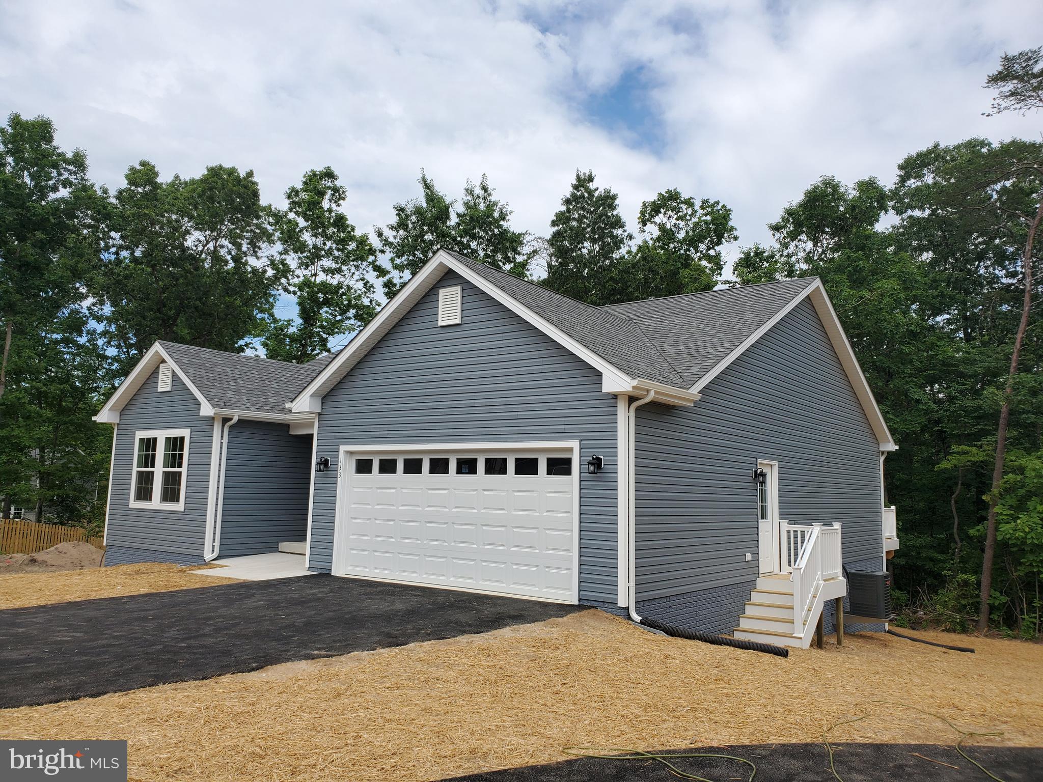 Ready Immediately! Brand new construction. This is the last lot left in the a small community with larger lots and located at the end of a cul de sac. This over half acre lot is wooded. Cute open concept rancher on a full basement with rough in plumbing for a 3rd full bath and a level walk out to the rear yard. Tons of privacy. Great room features cathedral ceiling and gas fireplace with slate surround and mantle. Large kitchen with breakfast bar, granite countertops and stainless appliances. 10 X 12 deck with vinyl rails off of Dining area. Mudroom off of garage features a large pantry and laundry room. The garage is fully insulated, dry-walled, with insulated garage door, openers and a unbelievable amount of electrical outlets. There is also a walk out door from the garage. Master suite has tray ceilings, ceiling fan and large walk in closet with a window. Master bath has separate soaking tub, tiled shower with glass doors, double bowl sink. Hall bath also has tiled floors. All bedrooms have ceiling fans.