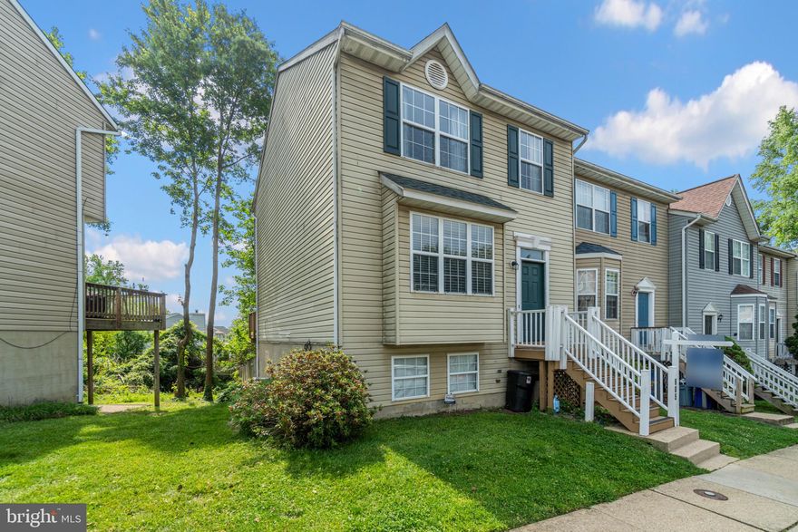 Beautiful end unit townhome conveniently located to major commuter routes, shopping, restaurants and more. This unit features a walk out basement to a fenced rear yard backing  up to trees.   This spacious 3 bedroom unit has a gas fireplace, dining area and large deck off main level and 2 dedicated parking spaces.