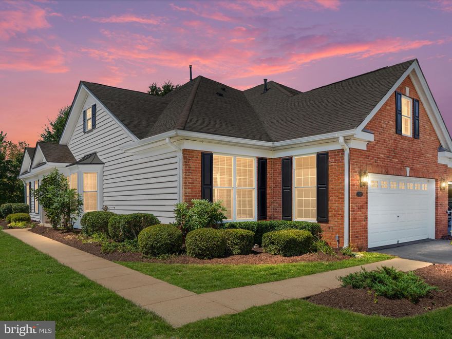 Discover the perfect blend of comfort and elegance in this beautifully maintained Toll Brothers Glenhurst model end-unit Georgetown, offering 1,814 square feet of single-level living in the coveted, Regency at Dominion Valley, 55+ active adult gated golf community. From the moment you step into the welcoming foyer with its gleaming hardwood floors and crown molding, you’ll feel the warmth and pride of ownership throughout. This bright and airy home is bathed in natural light from its abundance of windows, creating a cheerful and open atmosphere perfect for both everyday living and entertaining. The gourmet kitchen is a true heart of the home, featuring rich cherry cabinetry, granite countertops, brand new stainless steel appliances, a gas stove, recessed lighting, and a breakfast area with a charming bay window the ideal spot for your morning coffee. Enjoy special meals in the formal dining room with its timeless crown molding, or unwind in the spacious family room, complete with new plush carpet, a tray ceiling, and large windows framing serene views of trees, a pond, and the lush community grounds. Step outside to your covered patio and savor the peaceful surroundings, knowing that lawn care and exterior maintenance are all taken care of for you. The primary suite is a private retreat, featuring new carpet, a tray ceiling, crown molding, two closets, and a luxurious bath with a soaking tub, large shower with bench seat, and double vanity. Guests will feel right at home in the second bedroom and full bath, and the laundry room with washer, dryer, and utility sink adds extra convenience. Additional highlights include plantation shutters, new light fixtures and ceiling fans, a finished two-car garage with attic storage, wood shelves and an irrigation system. Major updates include roof scheduled to be replaced by the HOA & HVAC (2016) and hot water heater (2019). Life in Regency at Dominion Valley is about more than just a beautiful home it’s about the vibrant, active lifestyle. Your HOA covers Comcast cable and internet, trash and recycling, and access to world-class amenities including an 18-hole Arnold Palmer golf course, indoor and outdoor pools, tennis and pickleball courts, a fitness center, clubhouse, walking and biking trails, a dog park, and an exciting year-round calendar of social events. Whether you’re perfecting your golf swing, joining friends for a game of pickleball, or enjoying a sunset walk with neighbors, you’ll find every day here feels like Saturday! With a $2,088 one-time fee to Regency at Dominion Valley, a $1,000 one-time fee to Dominion Valley, a $547.73 monthly HOA fee, and a $66 monthly social membership, this is your opportunity to enjoy a low-maintenance, amenity-rich lifestyle in a welcoming 55+ community. Come see for yourself why so many love calling Regency home your next chapter begins here.