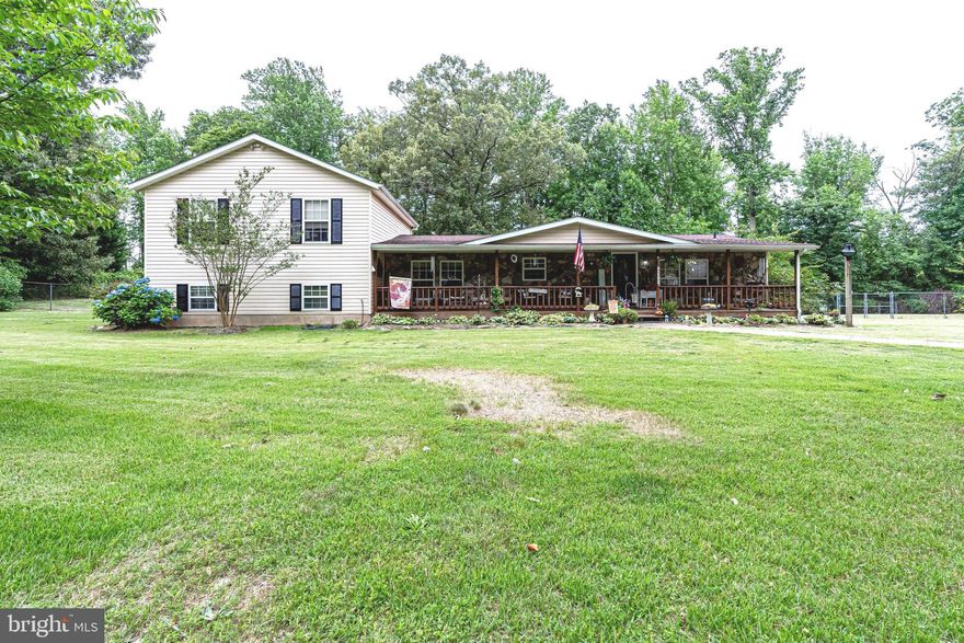 This charming 4 bedroom, 4 bath home on a 1.75 acre lot with mature trees and views of the woods is ready for new owners to make it their own! Tons of value in this unique tri-level house with a huge front porch with stone front that is perfect for relaxing in a rocking chair and enjoying the neighborhood. Open living room has a cozy stone fireplace and opens into the large kitchen with island and stainless steel appliances. The bonus sunroom features skylights and is filled with light! Two bedrooms upstairs, one on the main level, and the fourth on the lower level. Access the deck and fully (rear) fenced in yard - your pets will love this! Massive detached 30 x 40 foot garage with parking for 4 cars and extra storage. There is also a covered carport and two sheds! You can literally park 20 cars in the circular driveway! Walkout basement with an in-law suite that has handicap accessibility for a wheel chair to the room and bathroom . Close to I-95 and 15 minutes from Quantico Marine Base. Close to the Southern Gateway retail sector, shopping and dining. If you value privacy over the bustle of city living, this one is for you!