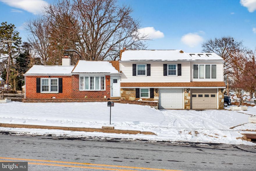 Discover the perfect blend of space, style, and versatility in this uniquely expanded home in Upper Moreland Twp, ideally located on a large corner lot within the highly regarded Upper Moreland School District and just a short walk to the middle school. Convenient to shopping, dining, and major roadways, this home offers both comfort and accessibility. You are welcomed by an expansive driveway and extensive hardscaping as you step inside to an impressive open-concept main level where original hardwood floors flow throughout the sun-drenched living room and set the tone for the home’s warm, inviting feel. The heart of the home is the updated, gourmet eat-in kitchen, featuring custom wood cabinetry, granite countertops, a tiled backsplash, updated appliances, and a breakfast bar—perfect for everyday living and entertaining alike. Elegant French doors lead into the expansive family room addition, a true showstopper with vaulted ceilings, recessed lighting, and a cozy gas fireplace wrapped in custom molding. From here, step outside onto a large patio in the fully fenced backyard, ideal for relaxing or outdoor gatherings. Upstairs, the primary suite serves as a private sanctuary and showcases a second major addition to the home. This retreat features a vaulted ceiling with skylights, a massive walk-in closet, and a striking glass-walled sitting area overlooking the backyard—an ideal space for a bright home office, reading nook, or morning yoga. Two additional generously sized bedrooms are also located on this level and share a full hall bathroom. A large storage area is conveniently accessed through the hall closet, as well as recessed lighting throughout this level. The finished lower-level room offers excellent flexibility and can easily function as an additional bedroom, home office, or recreation space. This level also includes a powder room and a large utility room with washer and dryer and side exit door. Down here also provides access o the oversized two-car attached garage, providing abundant storage and workshop space. Offering far more space than meets the eye, this home also also delivers peace of mind with many additional upgrades: new hot water heater (2025), 200 AMP electric service, newer roof (2016), central air and two zones of gas heating with main heater being newer (2020). A truly unique opportunity in a desirable Hatboro location.