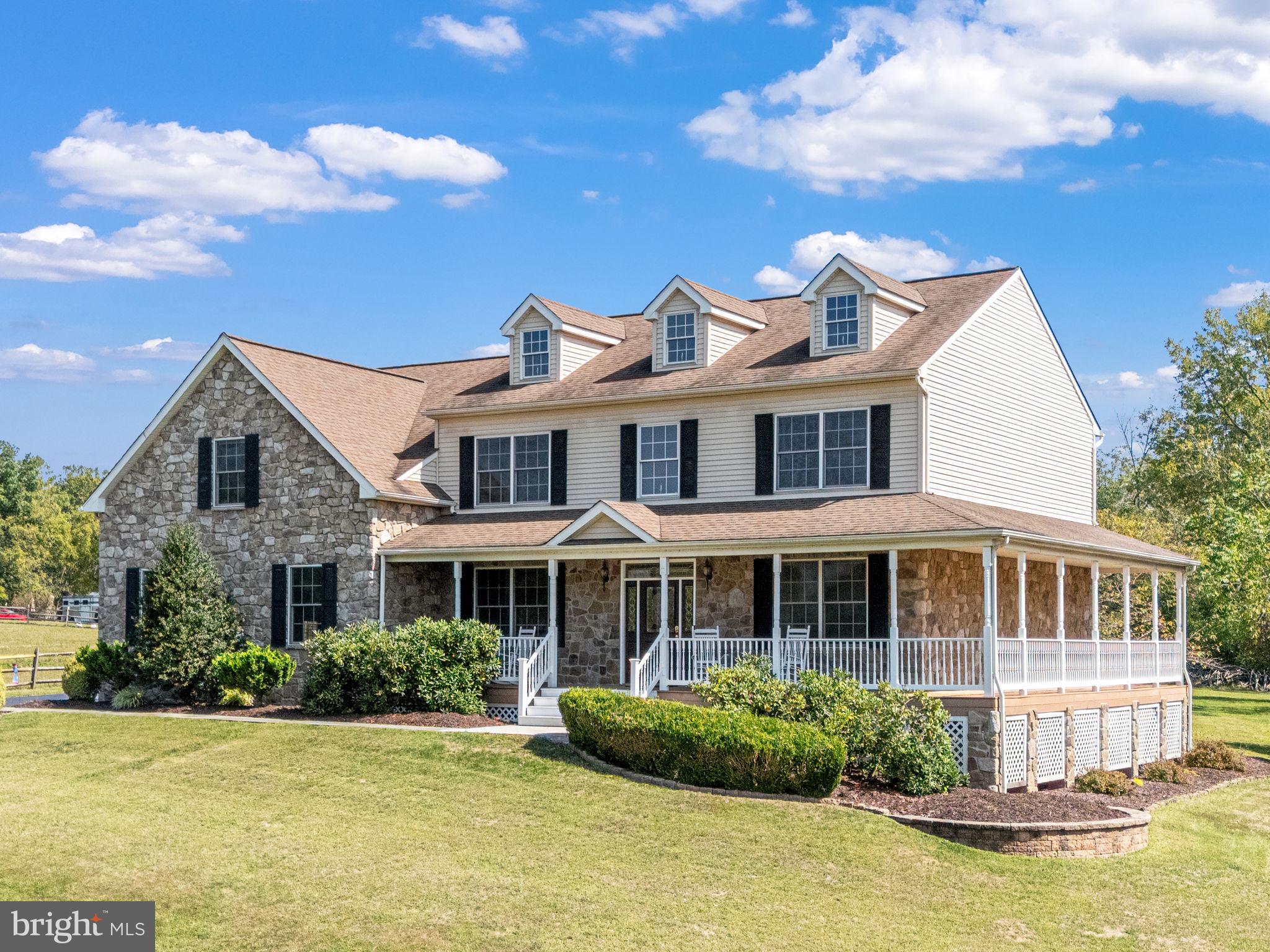 Nestled on just over an acre, this 4-bedroom, 2.5-bath home offers both spacious interiors and resort-style outdoor living. Step onto the wide wraparound Trex porch for morning coffee, then enjoy summer afternoons around the 35,000-gallon pool with slate & limestone waterfall, stamped concrete patio, and year-round Sundance hot tub. Inside, the two-story foyer welcomes you with hardwood floors and 9-ft ceilings. The main level includes a formal dining room, dedicated office, oversized powder room, and a large kitchen with island, tile flooring, and stainless appliances. The breakfast area opens to a dramatic two-story family room filled with natural light and anchored by a floor-to-ceiling stone fireplace. A versatile bonus room (game room), laundry, and garage access complete the first floor. Upstairs features four generously sized bedrooms including an expansive primary suite with walk-in closet, private bath, and sitting room with additional closets. A walk-up attic provides additional storage, while the basement with 9-ft poured walls and Bilco walk-out offers finishing potential. Additional highlights: 2.5-car epoxy-floored garage, newer HVAC systems, updated pool equipment, and new carpet. Conveniently located near trailheads, waterways, Skippack Village, and just a short drive to King of Prussia and Phoenixville.