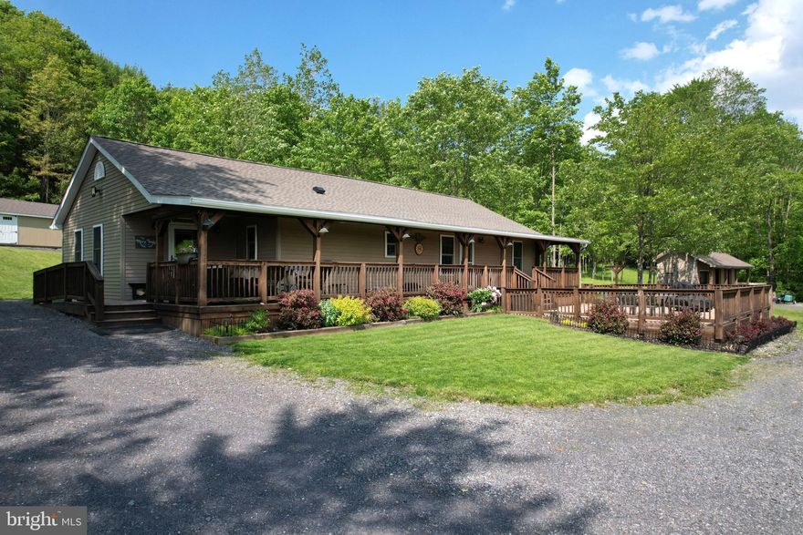 True One-Level Living on 2.80 Peaceful Acres.  Tucked away on a private lane, this beautifully maintained, one-owner home offers the perfect blend of comfort, charm & serenity. Set on 2.80 tranquil acres with a breathtaking mountain backdrop, the property provides that coveted sense of peaceful seclusion.  From the moment you arrive, you'll be captivated by the inviting curb appeal, full-length wrap-around covered front porch & stunning paver patio, ideal spots to relax, unwind & take in the scenic views & abundant wildlife.  Inside, you’ll find a warm farmhouse vibe enhanced by luxury vinyl plank flooring with a real wood look, freshly painted neutral tones and a seamless layout designed for true one-level living. The convenient first-floor laundry/mudroom features brand-new flooring, abundant cabinetry, countertop space & included stackable washer/dryer.  The spacious living room boasts a charming stone corner accent wall & an upgraded wood-burning stove (2022) a cozy & efficient supplemental heat source during chilly Pennsylvania winters. This space flows effortlessly into the cheerful dining area & the thoughtfully designed kitchen, which will delight any home chef. Highlights include granite countertops, a composite double-bowl sink with a gooseneck faucet, solid wood cabinetry, included stainless-steel appliances & a breakfast bar with stylish pendant lighting.  The serene owner’s suite features a private full bath with a new oversized vanity & a walk-in shower. A second bedroom & an additional full bath, also updated with a new vanity, provide comfort & flexibility for family or guests.  An additional highlight includes a brand-new heat pump/central A/C unit (2024). Outdoors, you’ll appreciate the 14x40 shed, perfect for storing yard tools, equipment, or toys, as well as a sidewalk leading to a convenient woodshed. Garden enthusiasts will enjoy the raised beds, flowering shrubs & blooming bushes that add even more allure to the landscape.  For outdoor adventure lovers, the Snow Shoe Rails to Trails Gillentown trailhead is just under half a mile away & easily accessible by ATV. Plus, you're just 3.5 miles from I-80, 19 miles from Bellefonte & 30 miles from Penn State University.  Whether you're searching for a full-time residence or a relaxing second home, this property checks all the boxes.  Take me home, country roads…your serene retreat awaits.