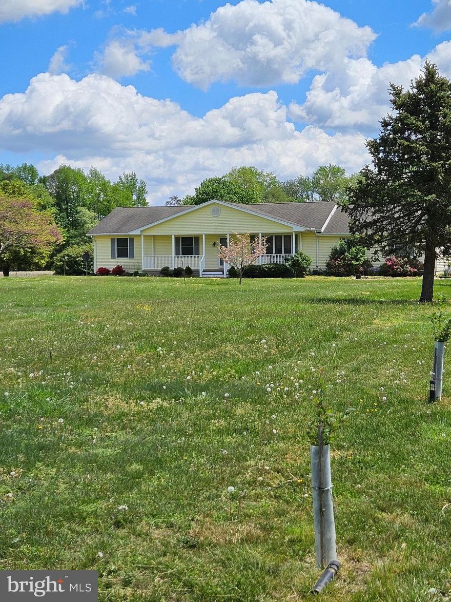 Outstanding small farm property on quiet country road!  This spacious home features 3-4 bedrooms and two baths,  kitchen with new stainless steel appliances, breakfast bar and dining area.  The large living room with wood floors over look the expansive front yard and opens to the front porch where you can enjoy your morning coffee.  In the rear of the home there is a large family room that offers a vaulted wood plank ceiling and has lots of windows to bring in an abundance of natural light and to gaze out at the fields and wild life.  There is also a mini split and free standing wood stove in the family room.   As you enter the attached garage you will find an extra room that could be used as a bedroom, hobby room or office and has a built in desk and plenty of shelving.  Enjoy the sun, family time or just relax on the large back deck.  The large outbuilding is 40 x 40 with cement floor, work bench and loft area for storage.   The current owners have planted many fruit and nut trees and have maintained the soil and fields etc in an organic manner.  Newly planted trees along the front road and along  the driveway lead to the back of the home and to the right of the back yard you will find an organic berry patch with strawberries and various berry bushes.