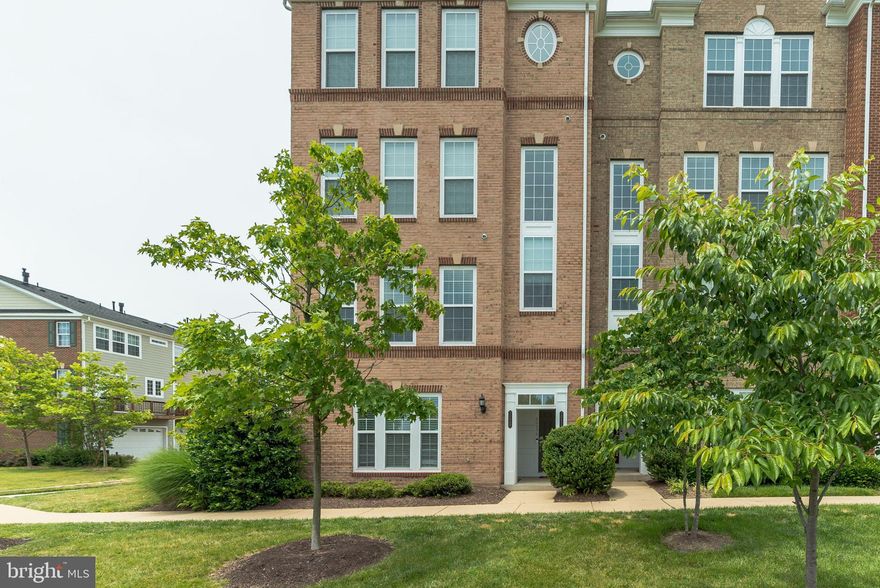 Totally move-in ready! This bright and lovely 3BR, end-unit condo offers comfortable and convenient living.  Well-maintained and in excellent condition, the entire interior of this former model unit has been freshly painted in a neutral modern gray that's a perfect background for any color scheme.  Lots of windows provide abundant natural light. Upgraded kitchen  with granite, 5-burner gas cooktop, island with breakfast bar, Samsung refrigerator and undercabinet lighting. Hardwood flooring on main level, neutral carpeting 2nd level. Ceiling fans in LR and all BRs. Spacious, sunny Master Suite with large walk-in closet, soaking tub separate shower and upgraded countertops.  Full size LG washer/dryer on 2nd level. Enjoy quality sound throughout the home and entertain in style with the built-in speaker system. Rear entry garage, painted walls.  Great commuter location near future Silver Line Metro.  Shops, restaurants, Harris Teeter close by.