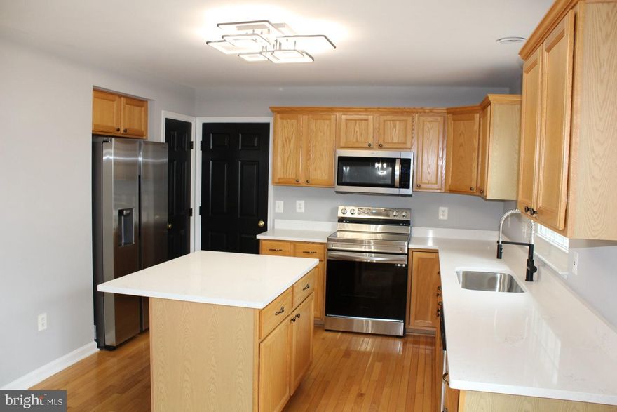 Priced To Sell Fast! Hot Updated 3 Level Brick Front Colonial with 2 Car Garage, Spacious Kitchen with QUARTZ Counters, Stainless Steel Appliances, Island, Finished Walk Out Basement, Soaring 2 Level Entryway, Spacious Bedrooms, New Custom Paint, Updated Bathrooms, New Flooring, New Lighting, Hardwood Floors, Jetted Bathtub, Walk In Closets, Fireplace, Deck, Much More!! Close to Schools, Shopping, and Commuter Routes.  This Will Not Last!