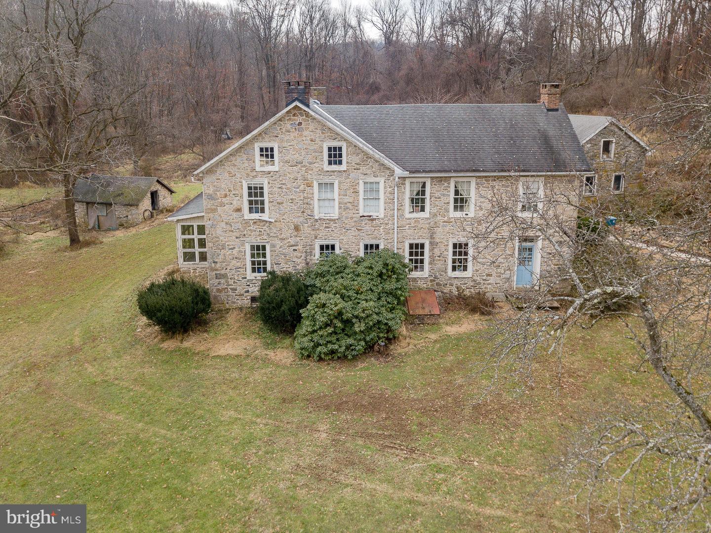 Own a piece of history! Historic 5-6 BR farmhouse. The oldest part of thehome was constructed in the 1700's. The 4.5 acre sloped lot features thefarmhouse, barn, summer kitchen and spring house. The spacious kitchenwas updated in 2006 and has granite counter tops and a butcher blockisland. Updated electrical panel. The office addition was built in the 1980's.Charming wide plank floors and deep windowsills. There is a glass porchand a sun room on the main floor. All of the bedrooms are spacious.Plenty of hardwood floors and built in shelves throughout the home.