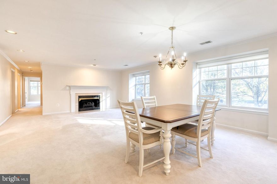 Exceptional Properties. Exceptional Clients. Welcome to 4500 Chaucer Way, Unit 202—an elegant and move-in ready 2-bedroom, 2-bathroom condo in the heart of Owings Mills. This light-filled second-floor home offers a smart, open layout ideal for both comfortable living and stylish entertaining. The living room features a cozy gas fireplace, built-in bookshelves, recessed lighting, and access to a private balcony—perfect for morning coffee or evening relaxation.

Just off the main living area, French doors open to a versatile den that works beautifully as a home office, sitting room, or flex space. The kitchen boast gleaming hardwood floors and a spacious center island, while the large walk-in pantry offers excellent storage for all your culinary needs.

The expansive primary suite includes a walk-in closet and an ensuite bath with a soaking tub and separate standing shower. The second bedroom and full hall bath are ideal for guests or family members.

You'll love the oversized utility room located off the hallway, which houses a brand-new washer and dryer (2025) and provides plenty of space for shelving or additional storage—functioning like a bonus closet. A brand-new water heater (2025) adds to the home’s value and peace of mind.

Centrally located near Foundry Row, Mill Station, Metro Centre, and major commuting routes, this home offers the best of lifestyle and location in Owings Mills.