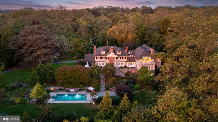 Live authentically. Located in the heart of Ruxton. Circa 1903. Relish the drive home through whispering woodlands. A refuge of tranquility awaits. Immerse yourself in the boundless beauty that unfolds. Extensive expansion by renowned architect Patrick Sutton and Winchester Construction Builders. Abundant windows invite radiant light throughout, while eight fireplaces punctuate the home, each a warm centerpiece of comfort and elegance. Your inner chef will flourish in the cooking space where the soul and senses entwine. The glamorous owner’s suite is a private sanctuary of calm and refinement. Fully finished lower level. Sweeping patios and porches stretch outward, seamlessly blending indoor and outdoor living. An expansive 81 ft. bluestone terrace invites unforgettable alfresco dining beneath the open sky. Surrender to the lush embrace of thriving gardens as you merge effortlessly with the outdoors. Savor every sunrise, then let your body flow through the sparkling embrace of the sublime pool. Recharge in the ambiance and let your energy be restored. Each scene awakens the senses, like a painting brought to life. The landscape becomes a living canvas, ready for the next chapter of your life. Verizon Fios Internet. Cultivate your existence. The art of uniting human and home.