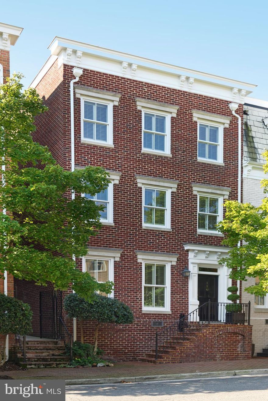 Stunning three bedroom, three and one half bath townhouse offers classic features with timeless elegance.  This semi-detached brick home is ideally located in Old Town, just two blocks from King Street and one block from the Potomac River and Founders Park.  Finely appointed with custom cabinetry, a few special features include rich hardwood floors throughout, handsome detailed moldings, tall windows, and  two gas fireplaces. With tall windows and custom millwork on either side of the fireplace, the spacious dining room could easily become the new owners' living room.  The intimate living room parlor framed by wide door casings easily accommodates seven or eight people.  The sun-filled chef's kitchen with adjoining family room boasts new 2020 stainless appliances, high ceilings with cove lighting and glass front cabinets  which divide the kitchen and family room spaces.   All the southern walls of this residence are windows and French doors, with wood plantation shutters. A wide flagstone terrace is just beyond the family room French doors, convenient for grilling most of the year.  The second floor offers a library or office, also with a gas fireplace.  A luxurious master suite with renovated bath includes double sinks, long vanity with many drawers, oversize shower with seamless glass door plus designer lighting.  A private hallway to his/her walk-in closets plus a wall of wardrobe built-ins will handle the most extensive closet needs.  The spacious master includes hardwood floors, a cold drink refrigerator,  TV and a safe are conveniences.  Two elegant guest room suites are located on the top floor, again with hardwood floors, a generous hallway with skylight and updated guest baths.  Another walk-in closet provides locked secure storage.  In the southern guest room there is a window bench and a bonus of interior bench space for wrapping paper and ribbon!  The laundry room is complete with upper storage cabinets.  Two off street parking spaces complete this extraordinary property.