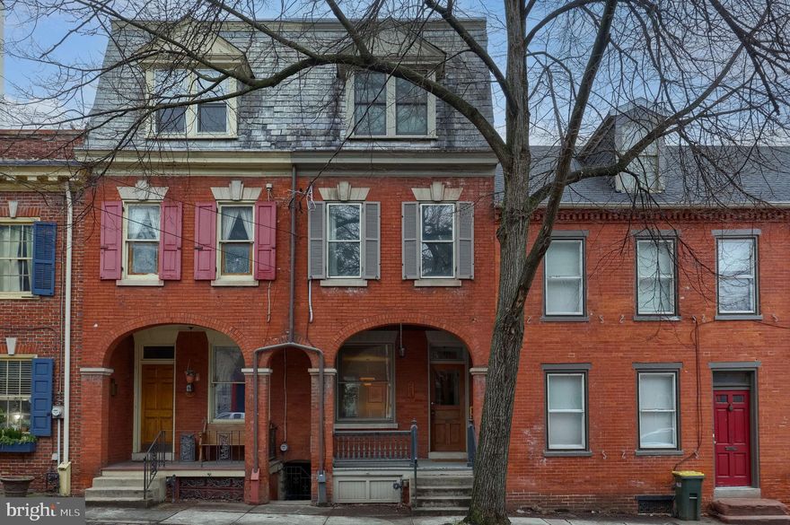 Welcome to this charming Victorian townhome that perfectly blends historic character with modern living. A classic brick exterior and inviting arched front porch set the tone, while inside, bright and open living spaces with classic hardwood floors create a stylish and flexible backdrop for any décor.
The living area flows seamlessly into the dining space—perfect for cozy nights in or entertaining guests. The updated kitchen is a chef’s dream, featuring a Miele induction cooktop, wall oven, ample counter space, a water filtration system, and a dedicated drinking water faucet. A glass-paneled door leads to the hardscaped backyard, offering the perfect canvas for your outdoor retreat. Upstairs, you’ll find two sunny bedrooms, a full bath, and convenient second-floor laundry. The entire third floor is dedicated to a spacious primary suite with exposed brick walls, abundant natural light, and a luxurious bath complete with dual sinks, a shower, and a soaking tub—your perfect escape after a busy day. Located just steps from downtown parks, cafés, restaurants, and shopping, this home offers the perfect blend of historic charm, modern comfort, and a vibrant, convenient lifestyle. Don’t wait—schedule your showing today!
